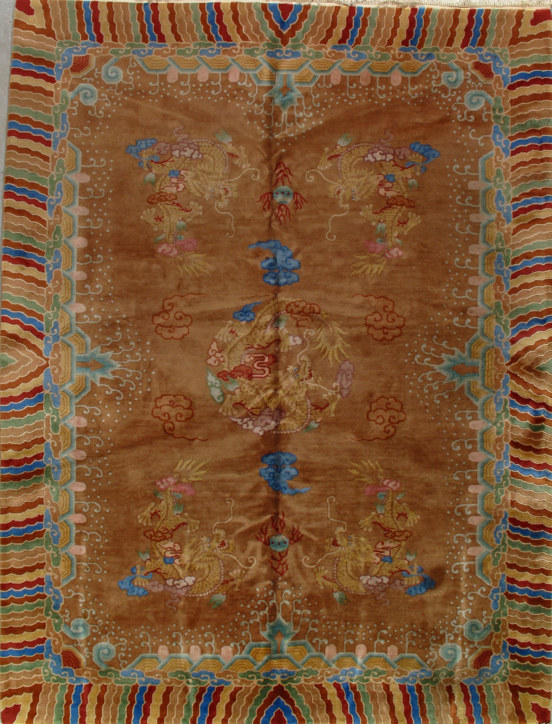 A rug with a colorful pattern on it is hanging on a wall.