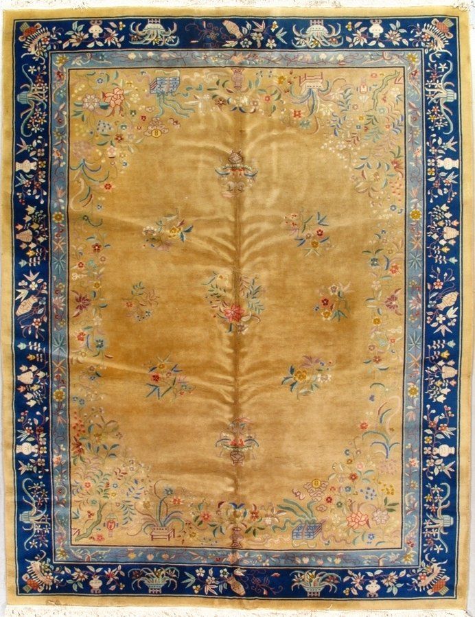 A rug with a blue border and flowers on it