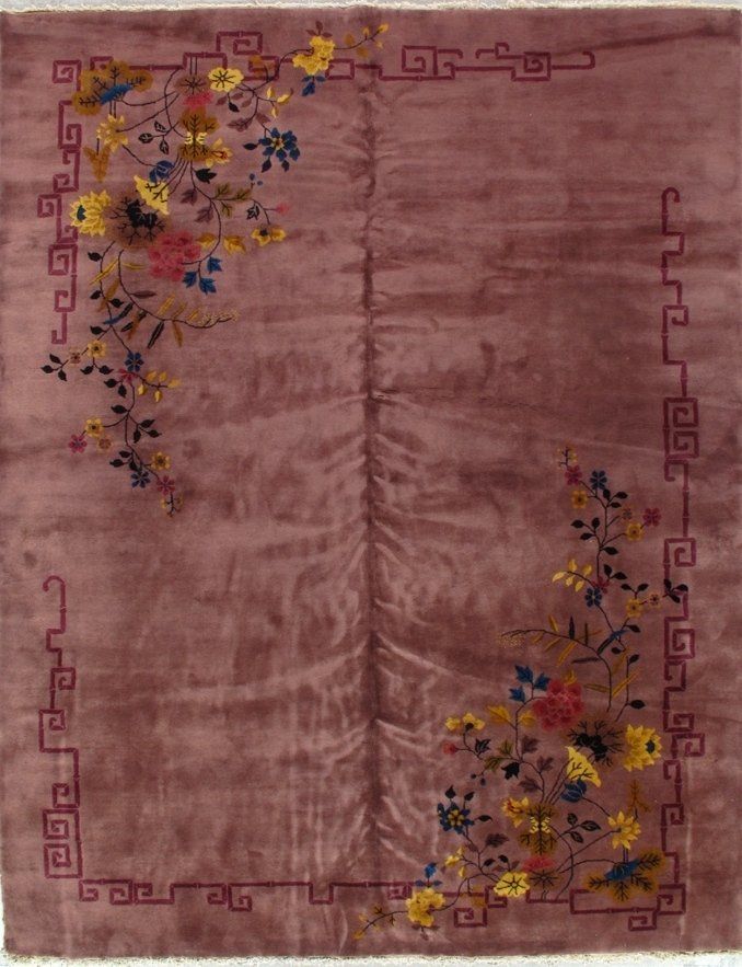 A pink rug with a floral design on it