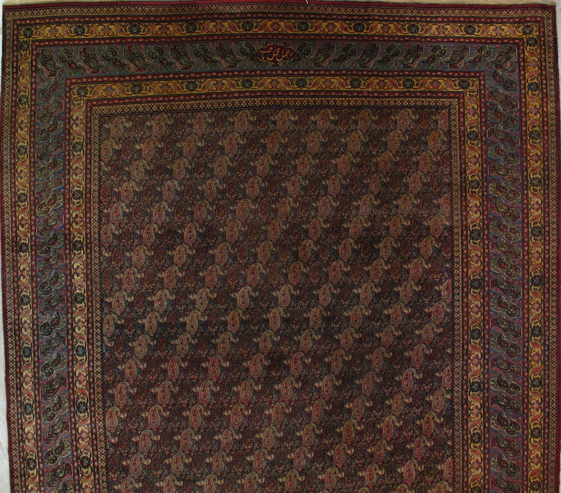 A rug with a floral pattern and a gold border