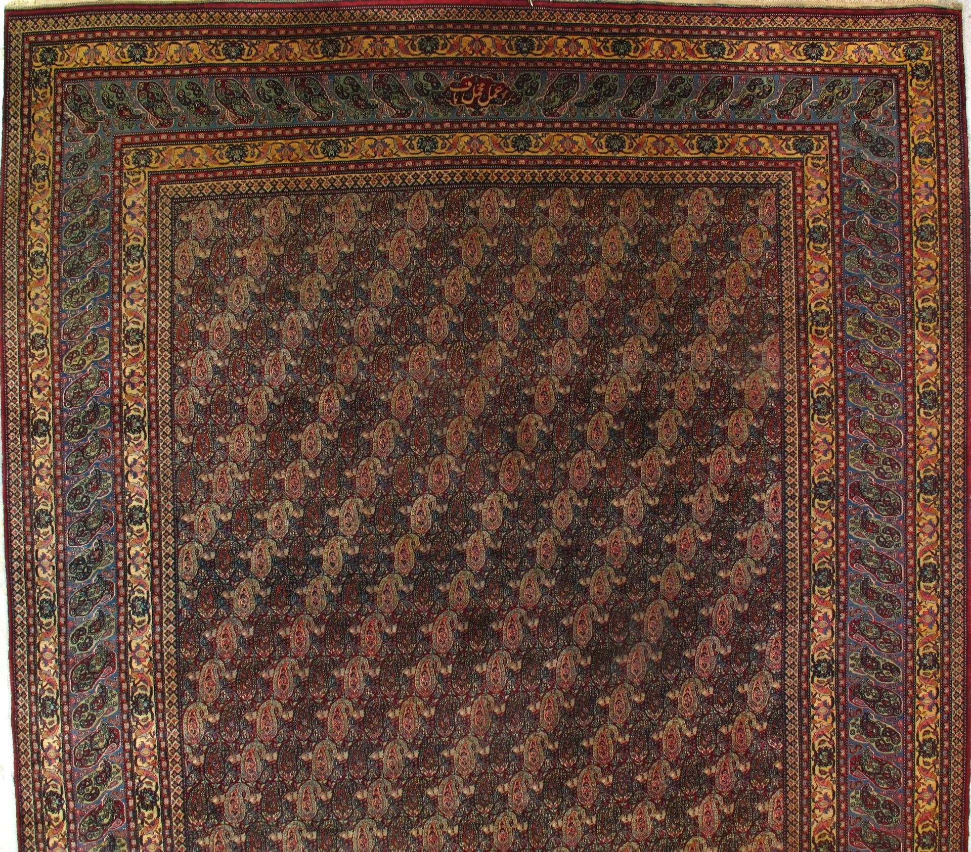 A rug with a floral pattern and a gold border
