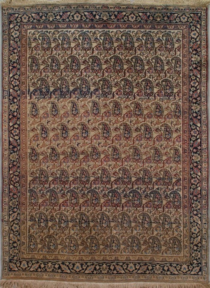A rug with a floral pattern on it is hanging on a wall.