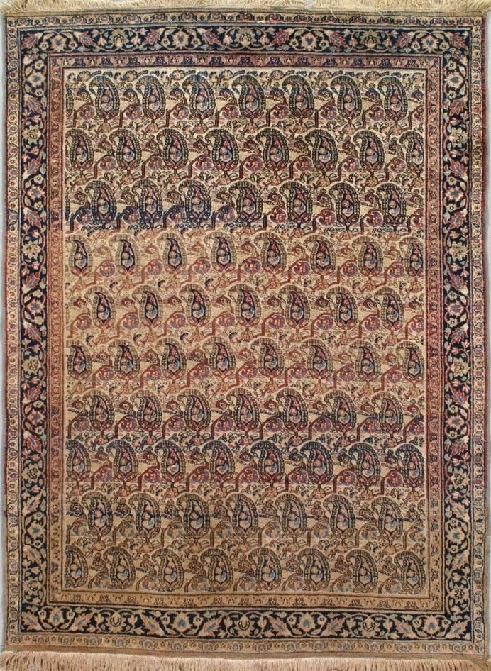 A rug with a floral pattern on it is hanging on a wall.