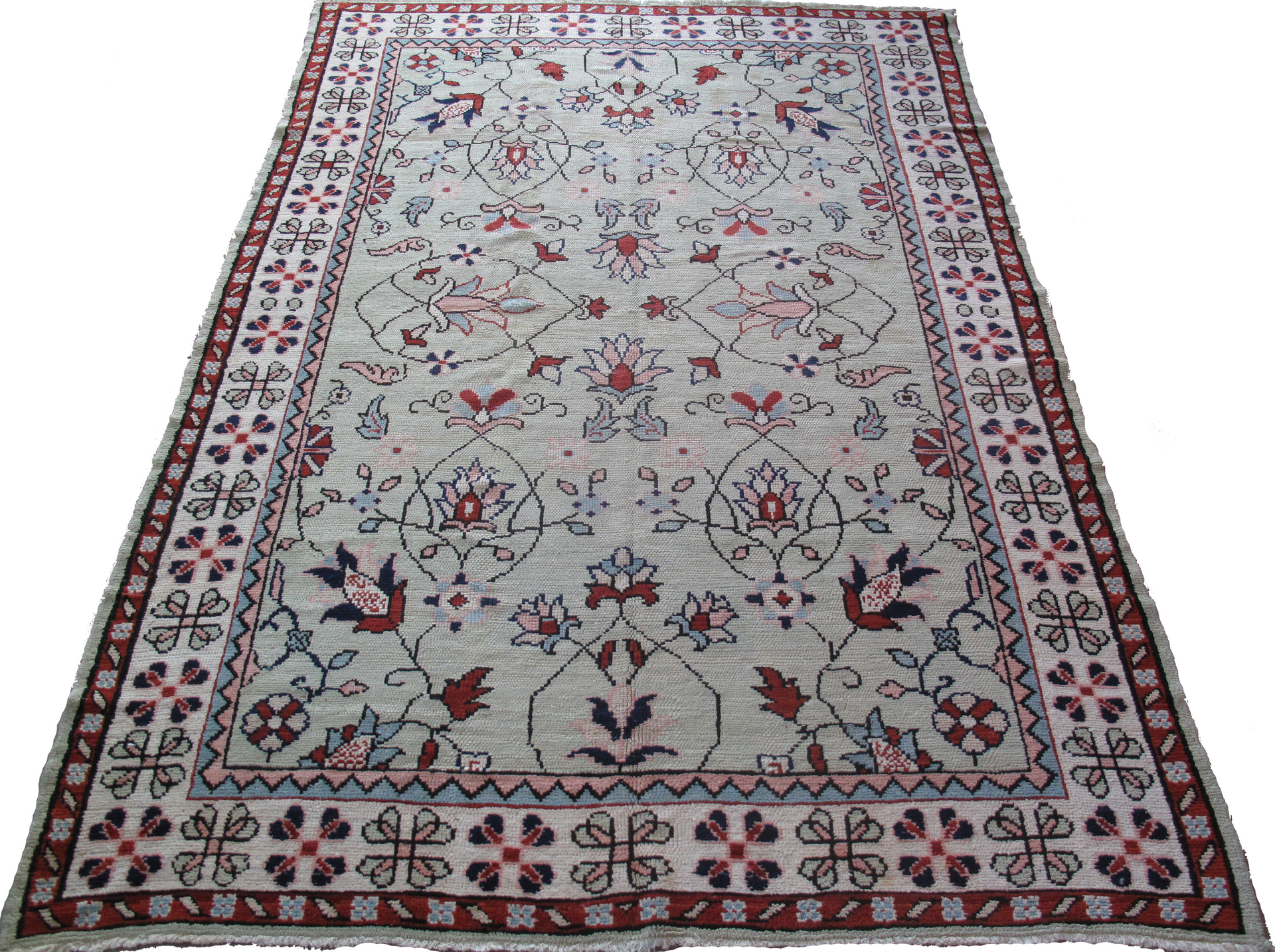 A rug with a floral pattern on it is sitting on a white surface.