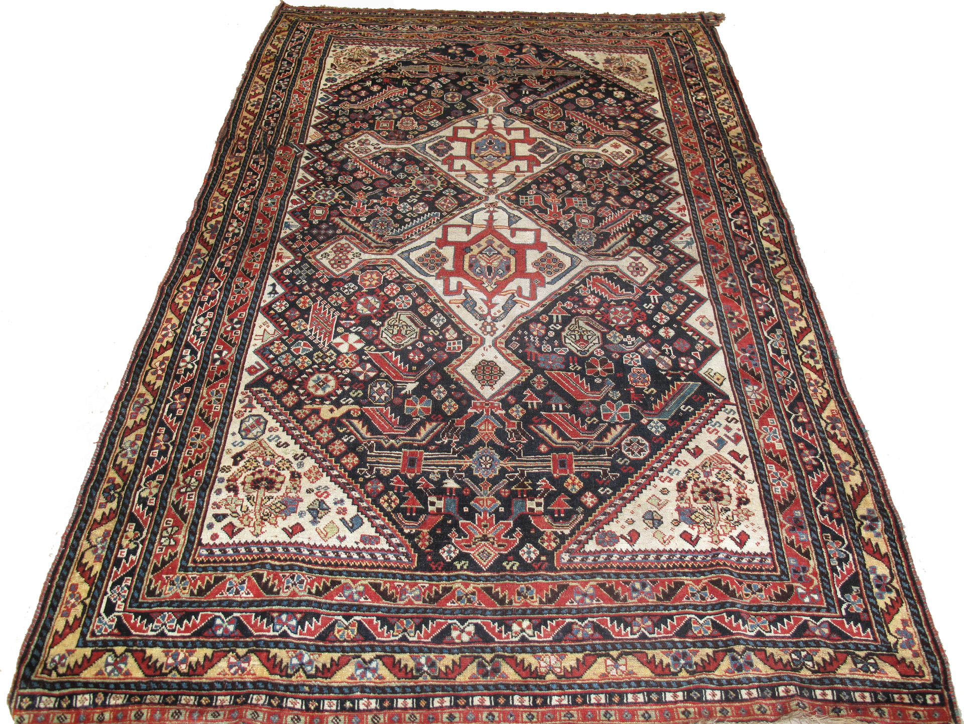 A rug with a geometric pattern on it is on a white background.