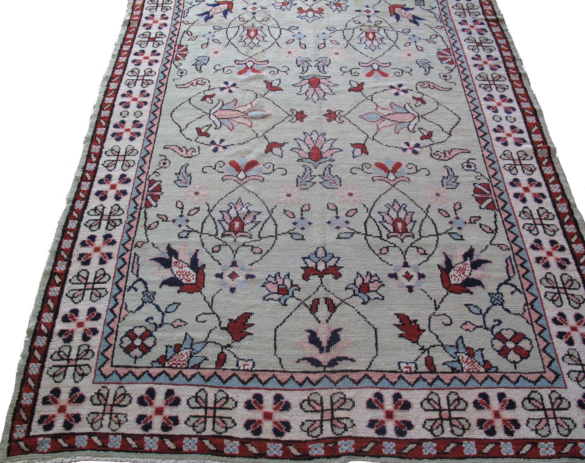 A rug with a floral pattern on it is sitting on a white surface.