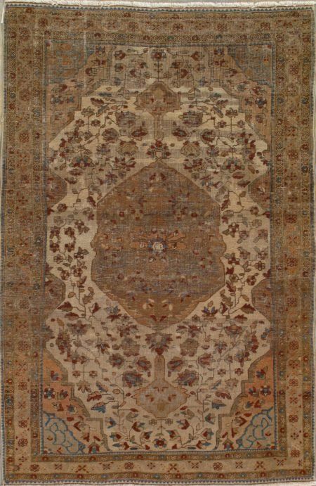 A rug with a floral pattern on it is hanging on a wall.