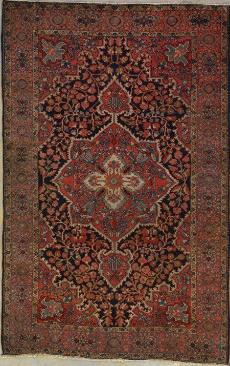 A rug with a floral pattern on it is hanging on a wall.