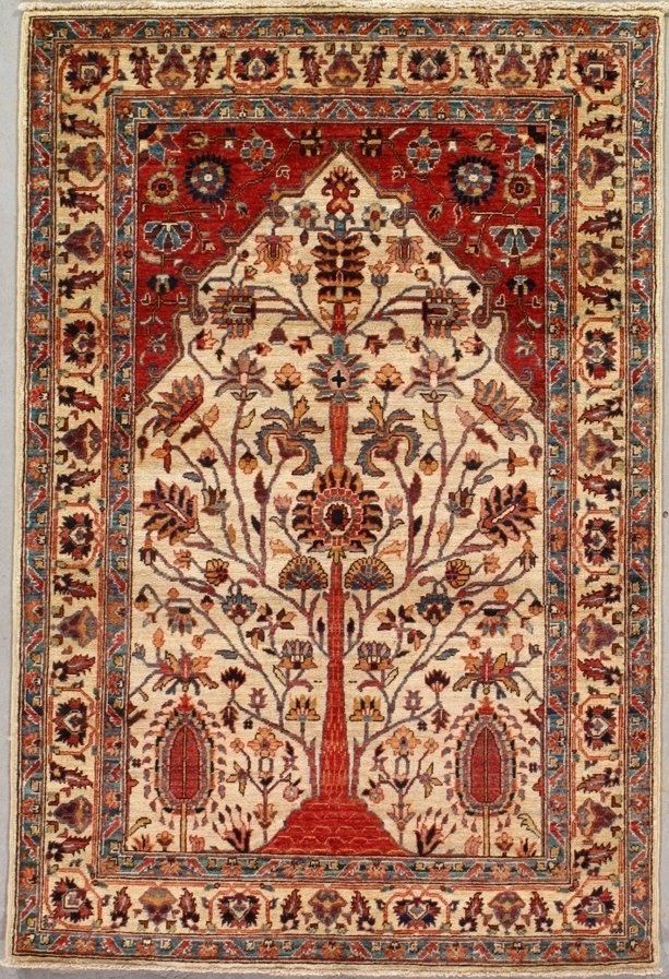A rug with a tree on it is hanging on a wall.