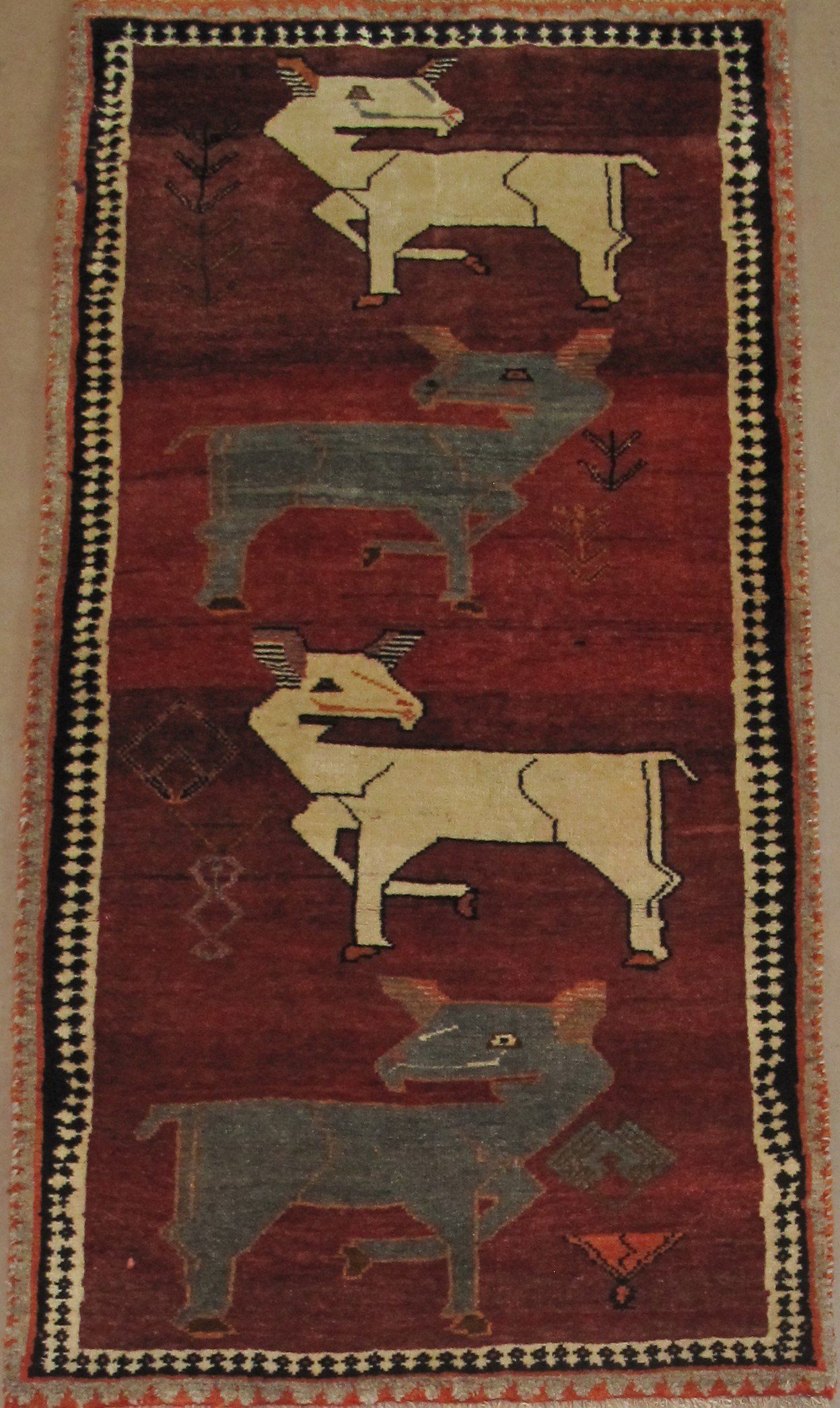 A rug with a pattern of cows on it