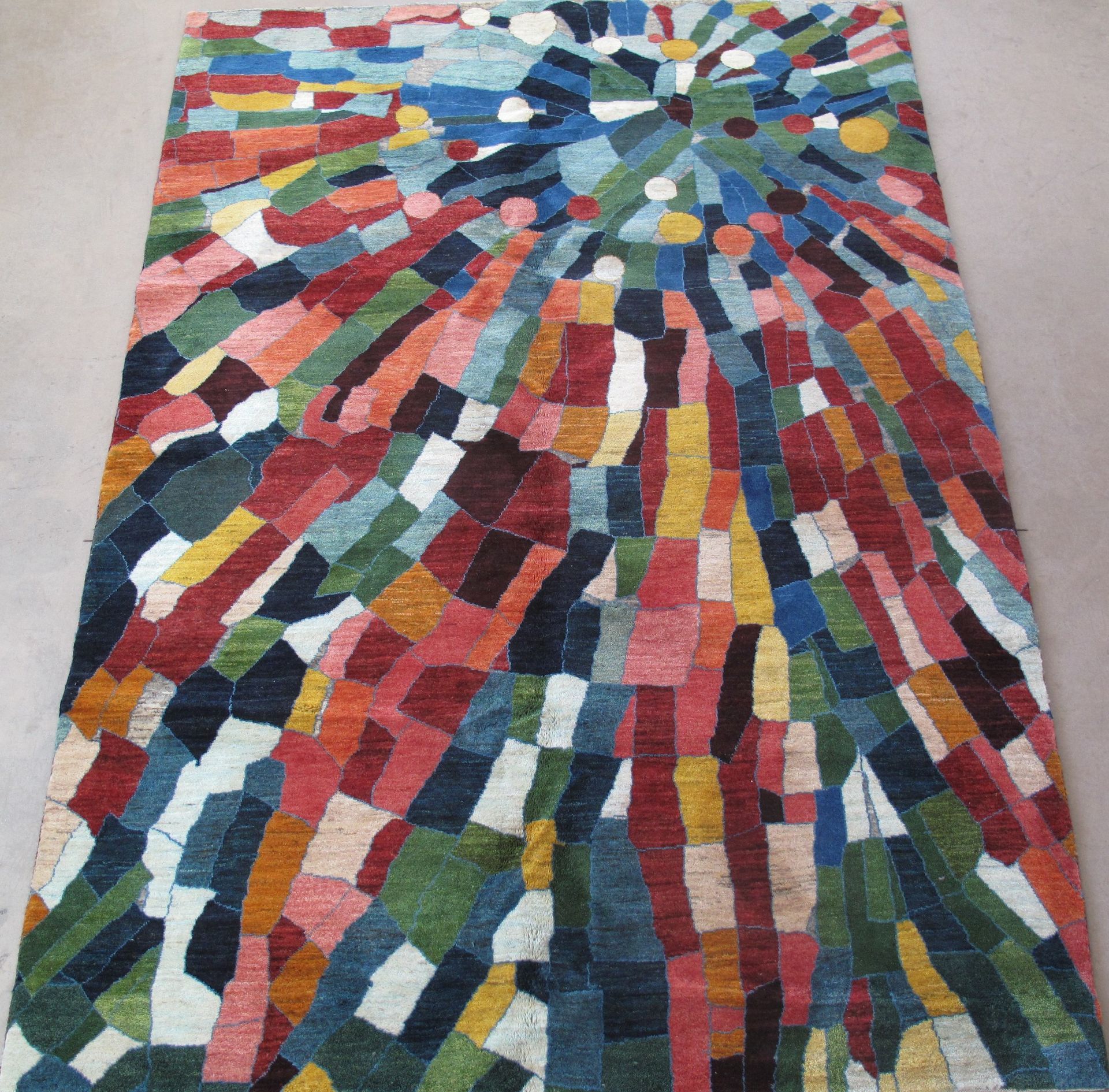 A colorful rug with a circular pattern on it