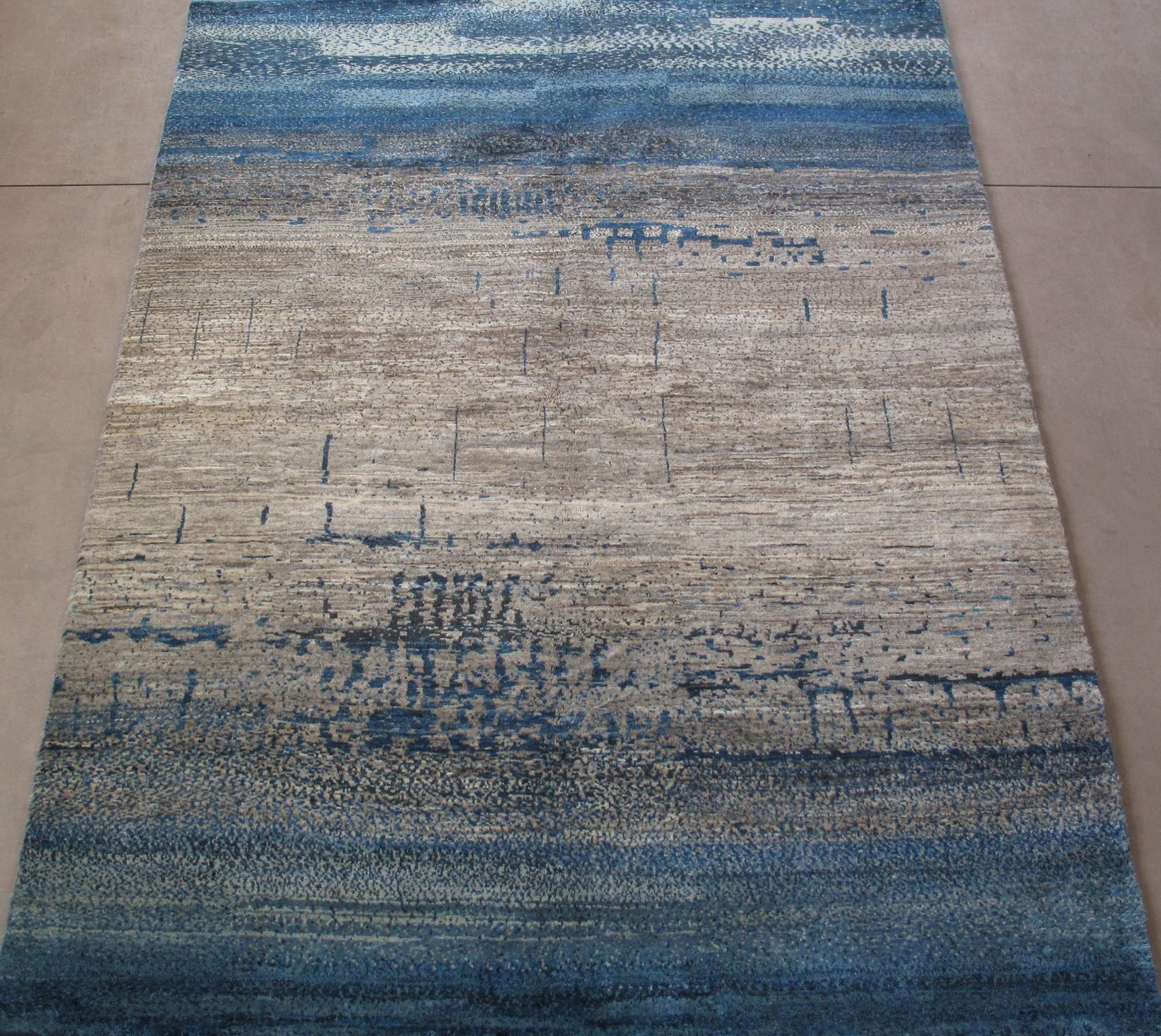 A blue and white rug is laying on the floor