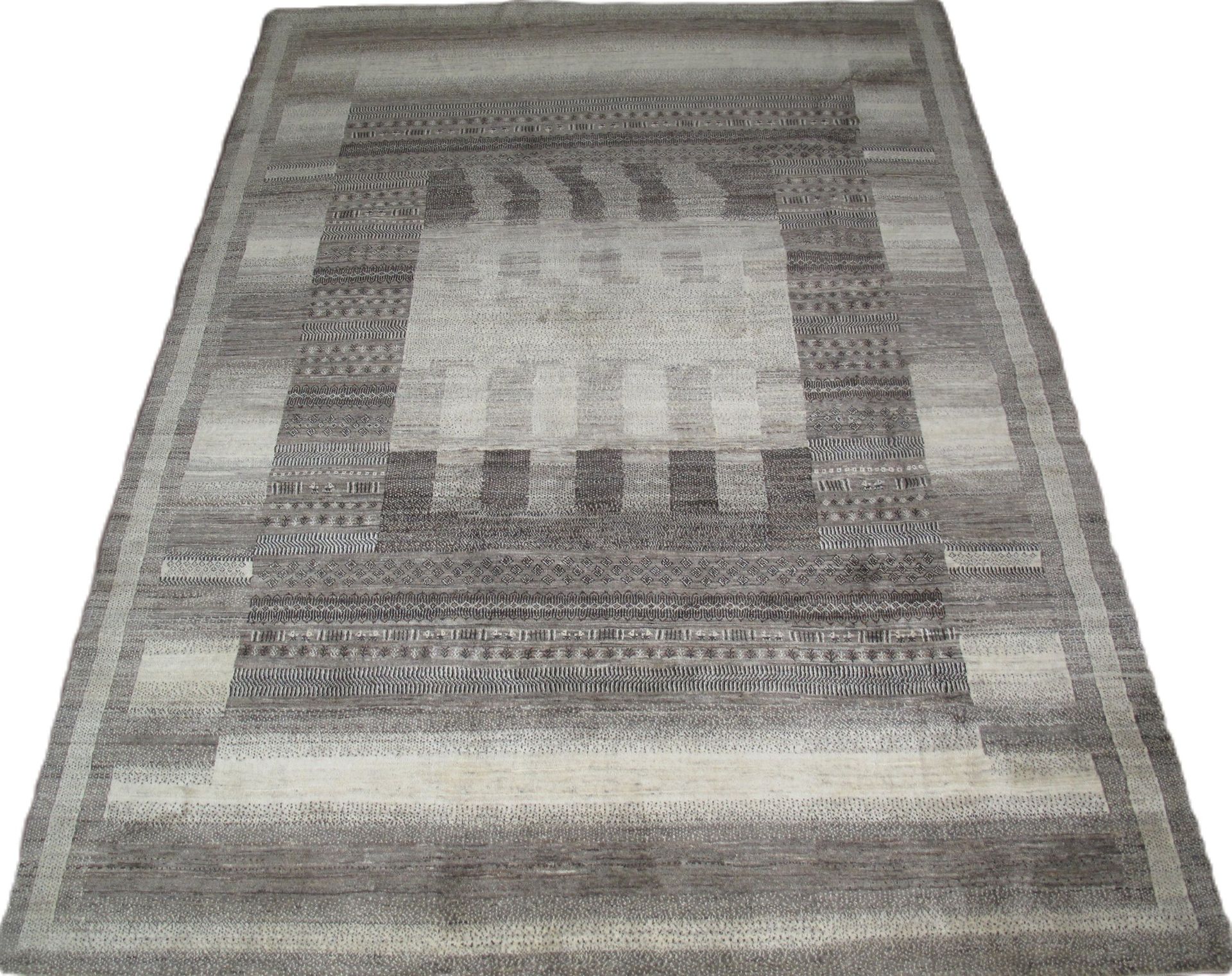 A rug with a pattern on it is sitting on a white surface.
