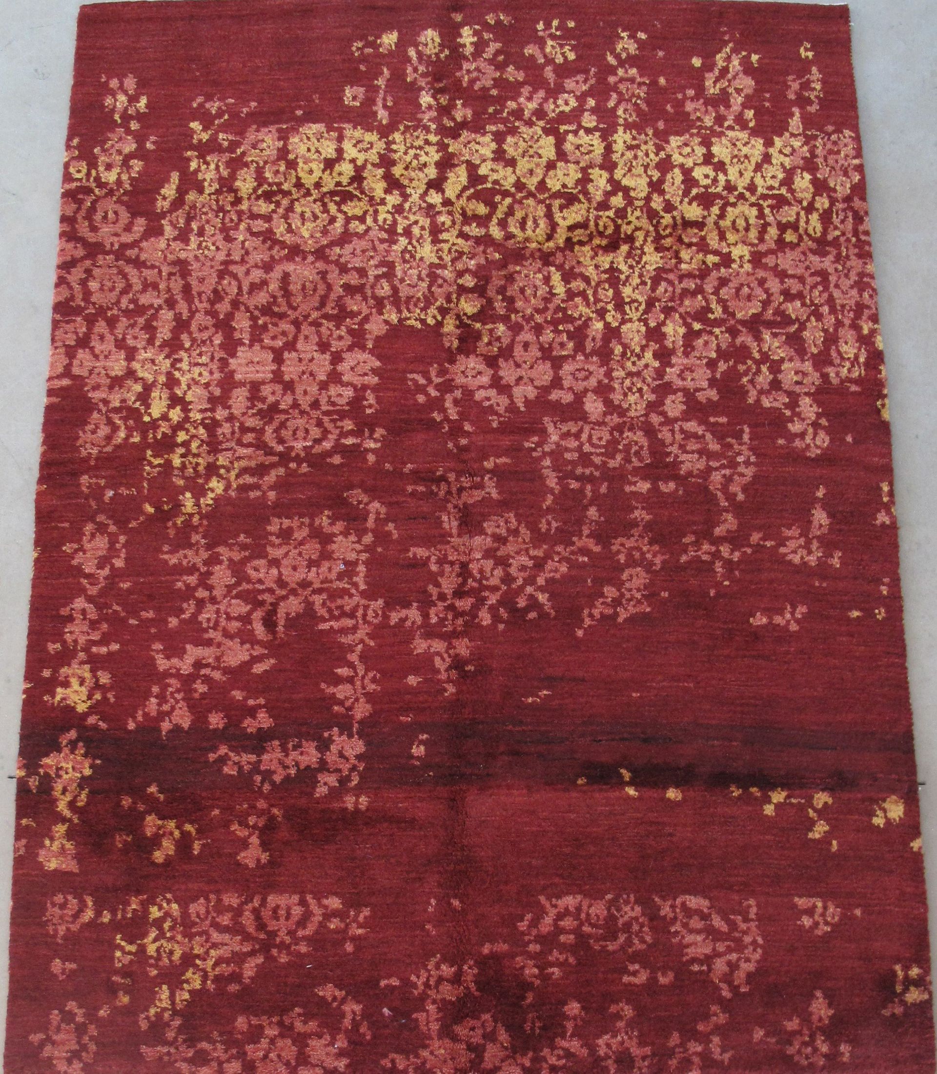 A red rug with a gold pattern on it