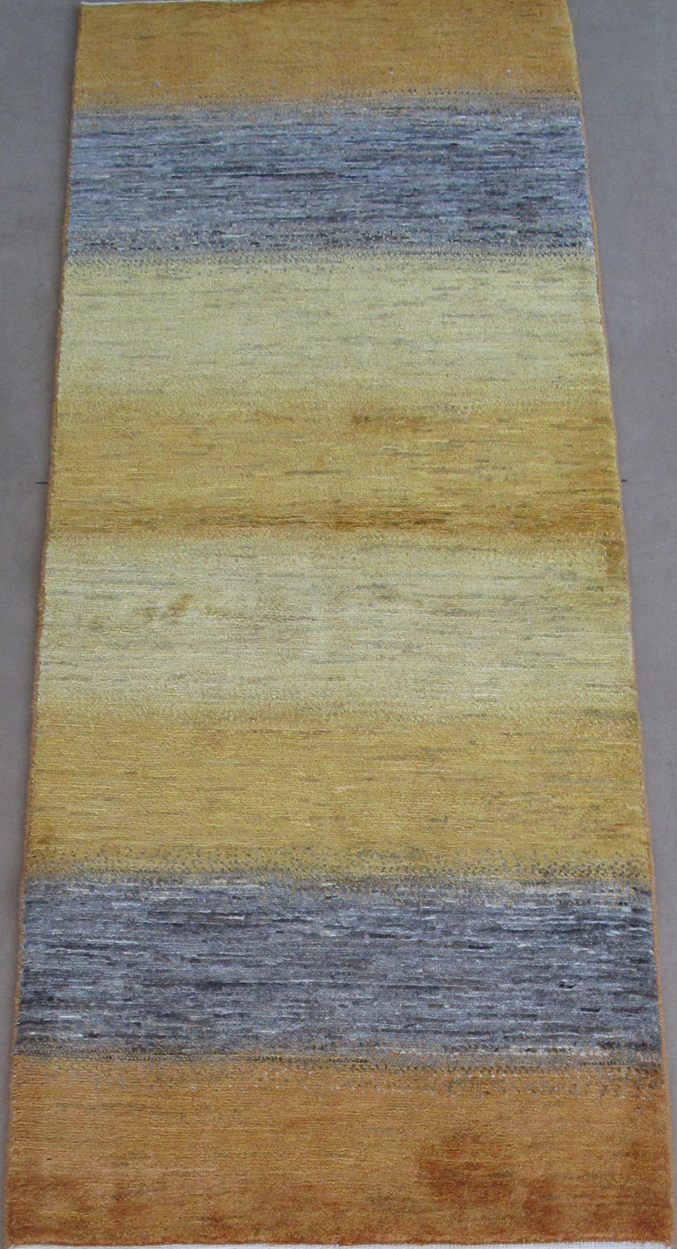 A yellow and gray striped rug is sitting on a table.