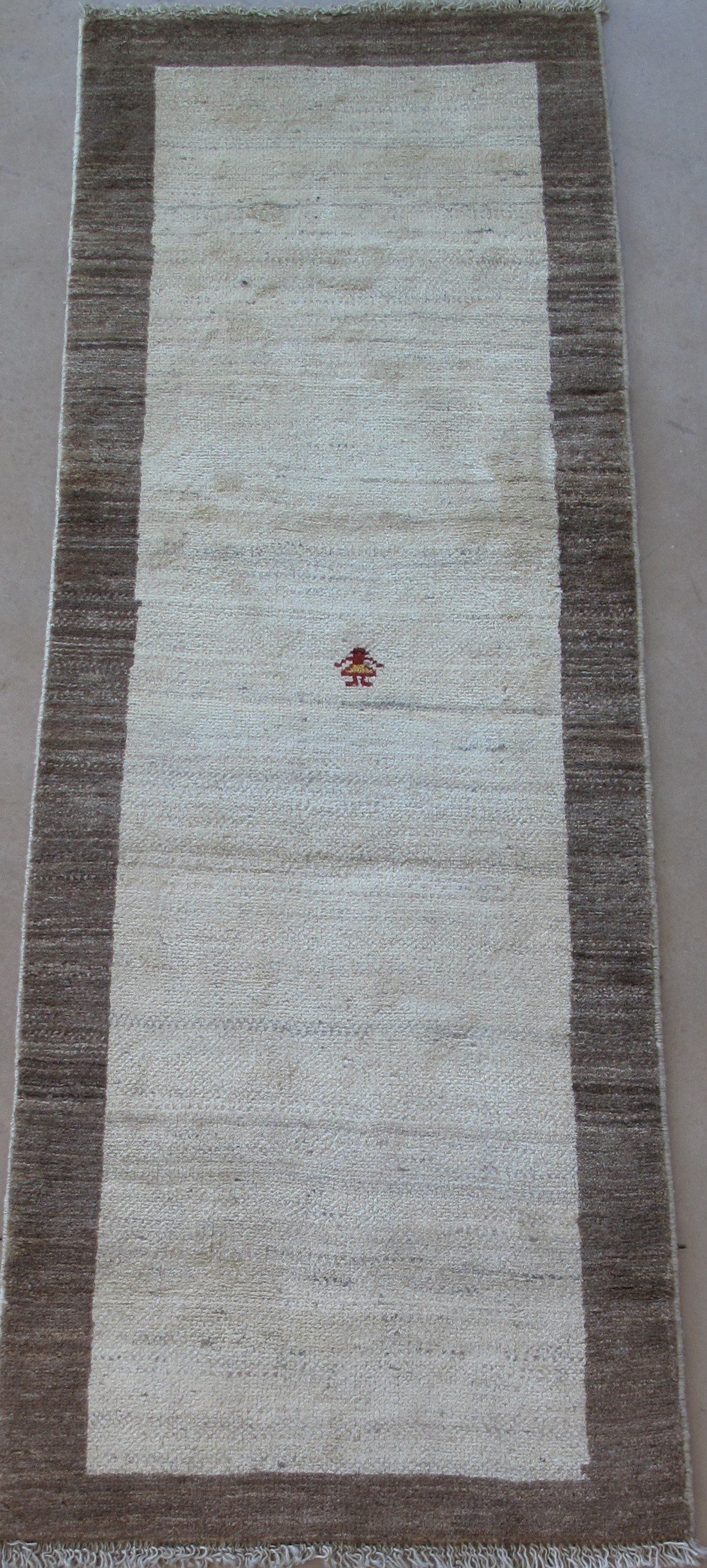 A rug with a brown and white border is sitting on a table.