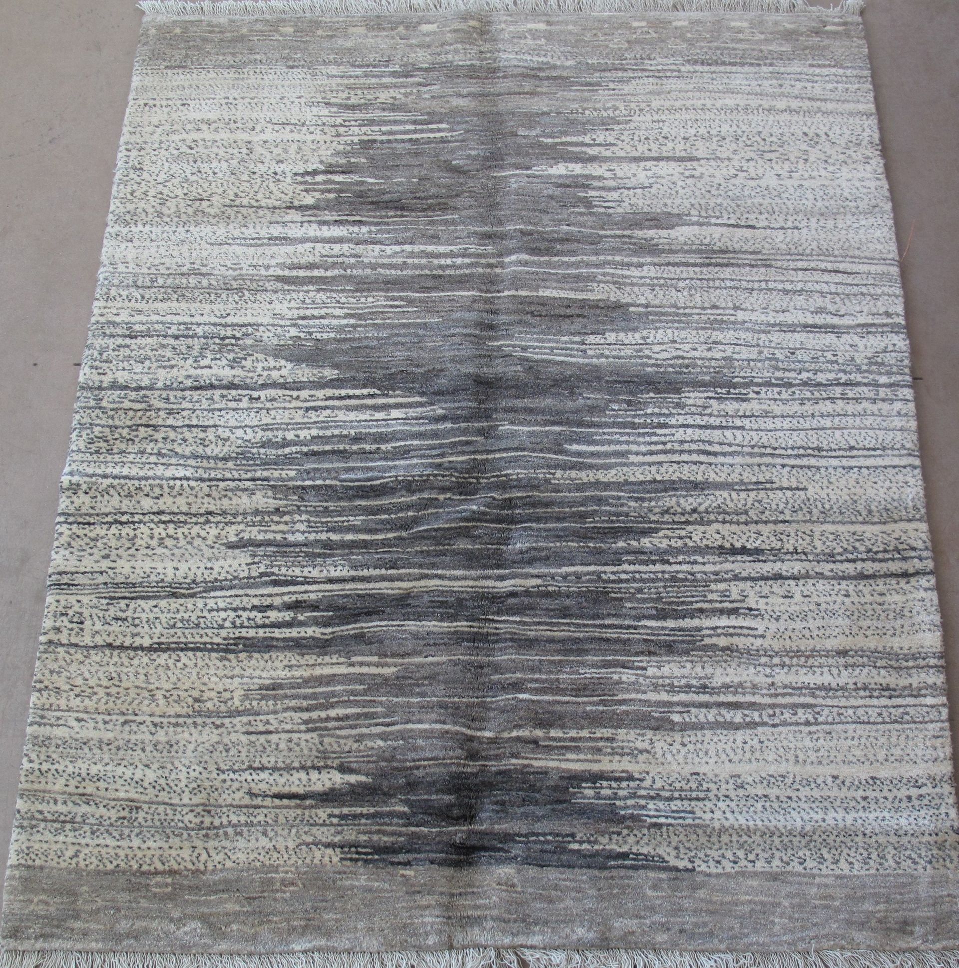 A rug with a striped pattern is sitting on a table.
