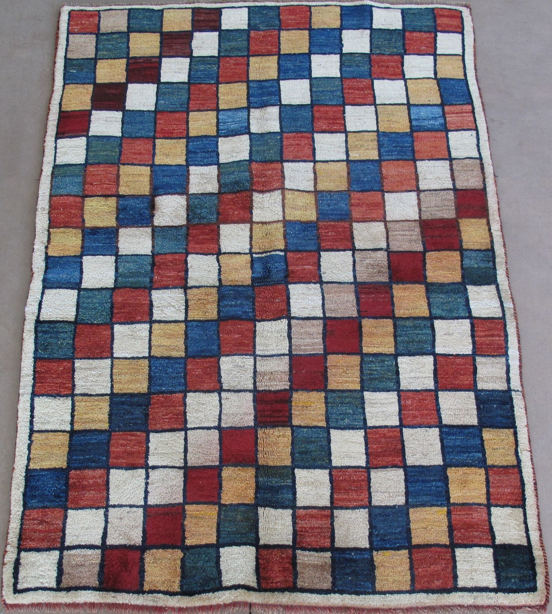 A colorful checkered rug is sitting on the floor