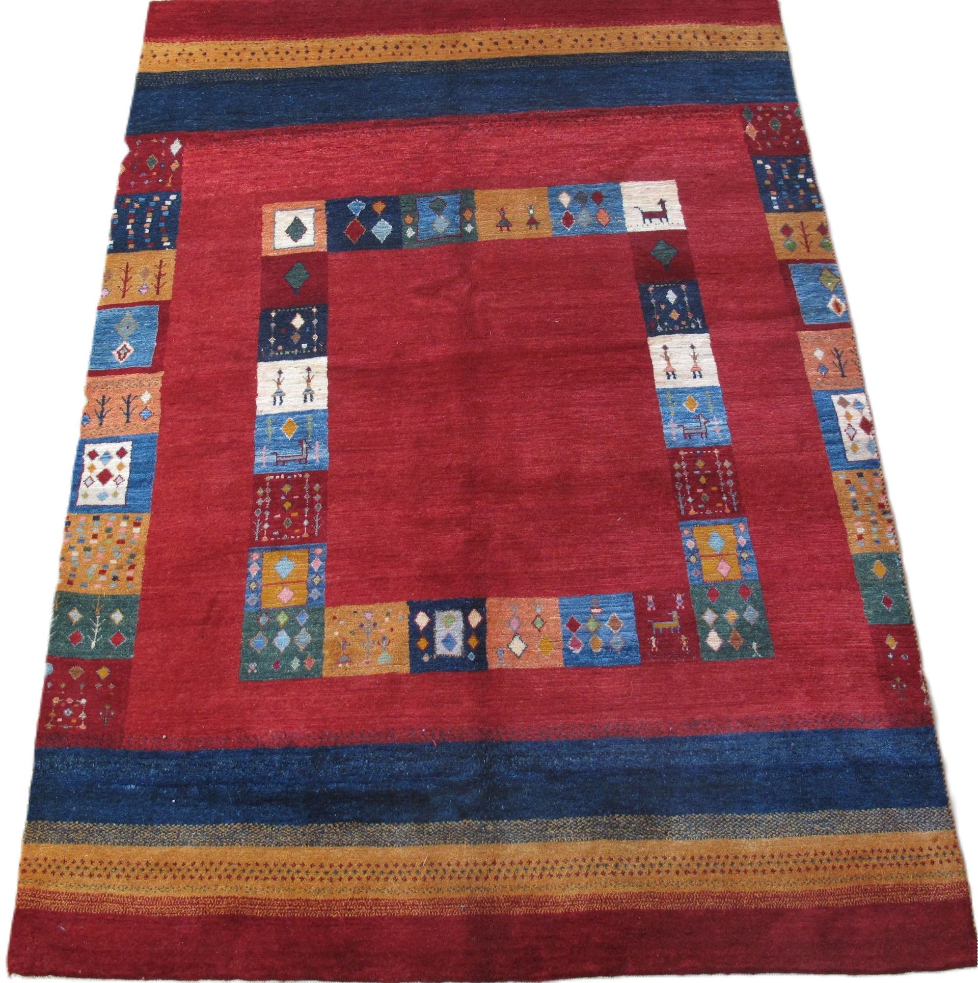 A red rug with a blue and yellow border