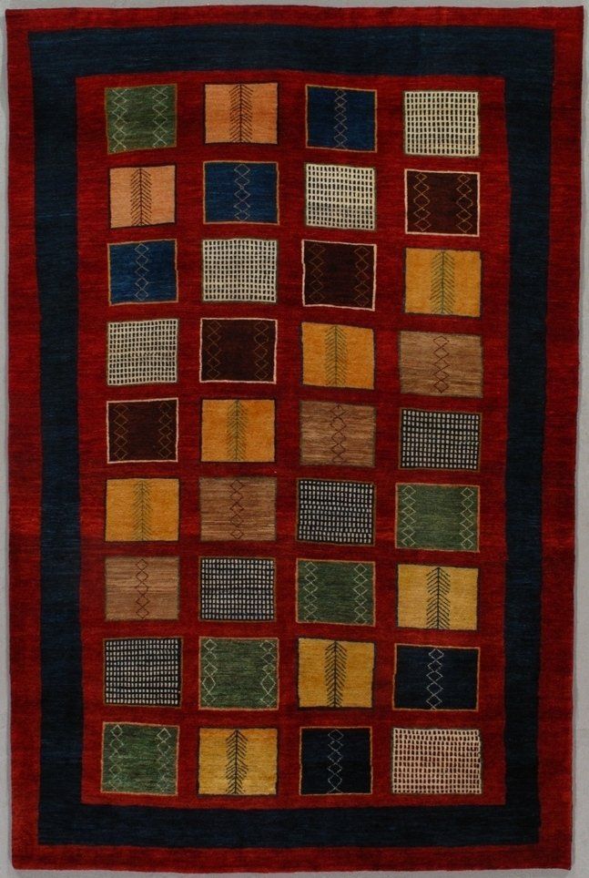 A red rug with blue and yellow squares on it