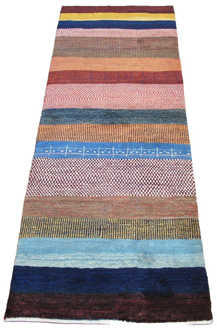 A colorful striped rug is sitting on a white surface.