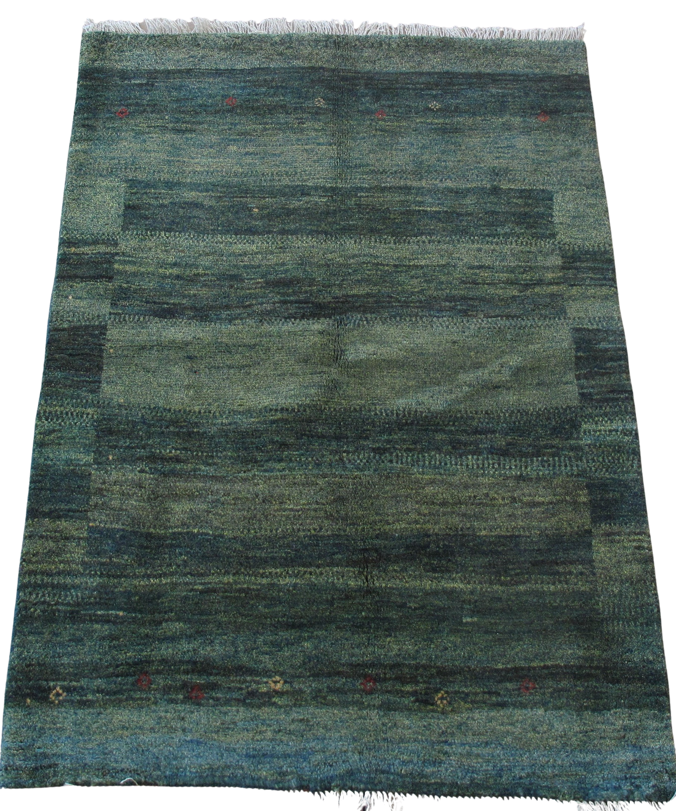 A blue rug is sitting on a white surface.