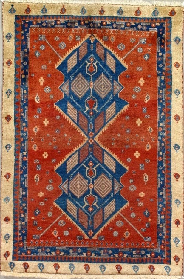 A red and blue rug with a geometric pattern on it