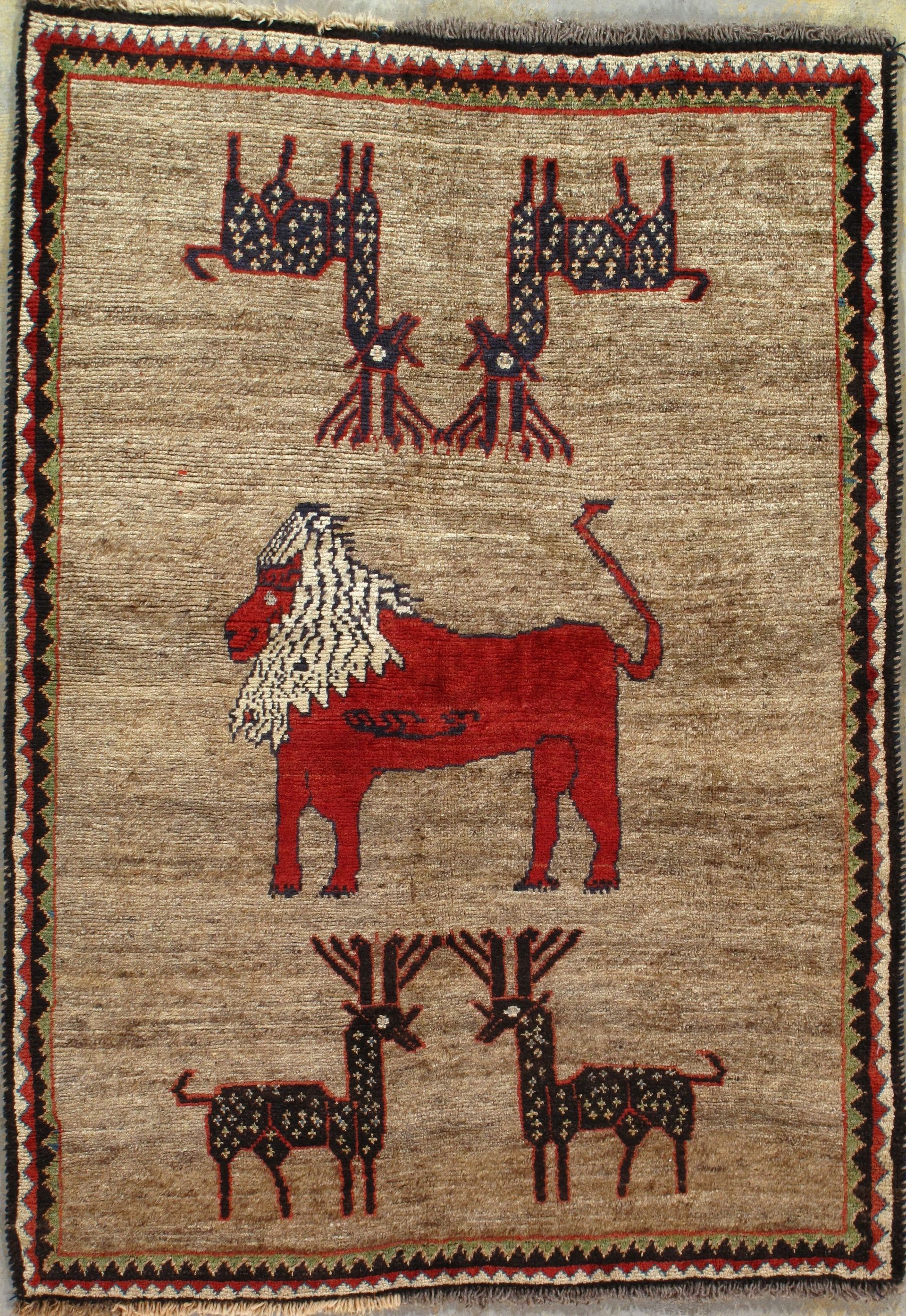 A rug with a lion and two deer on it.