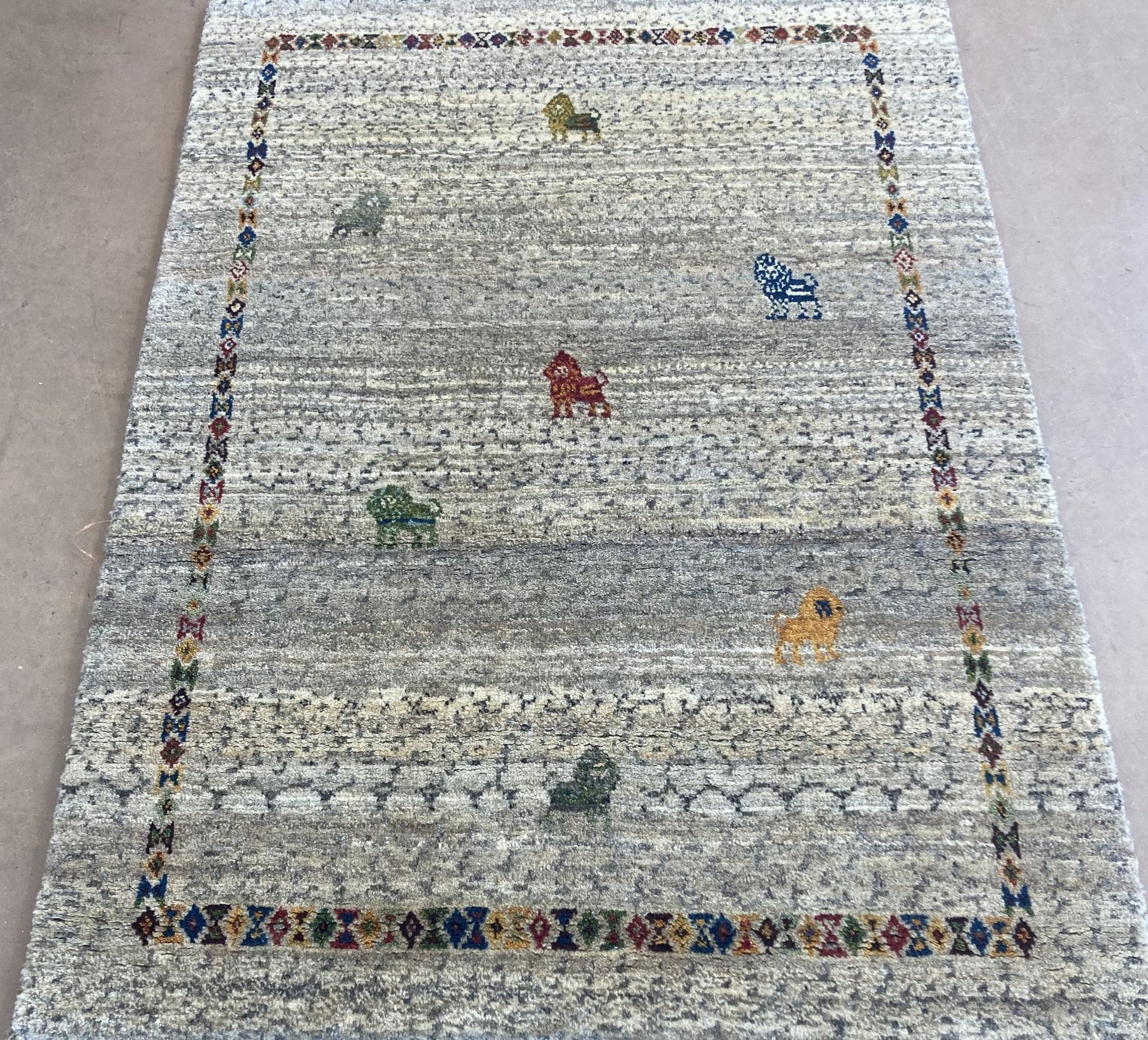 A rug with horses on it is on a table