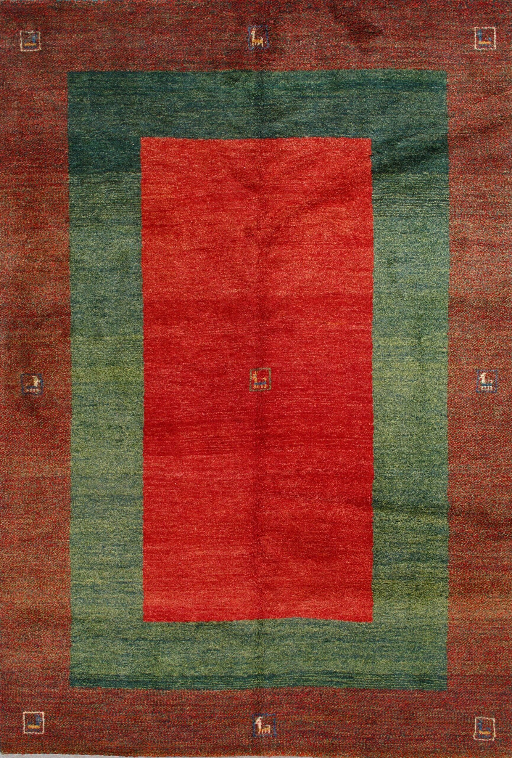 A red and green rug with a red square in the middle.