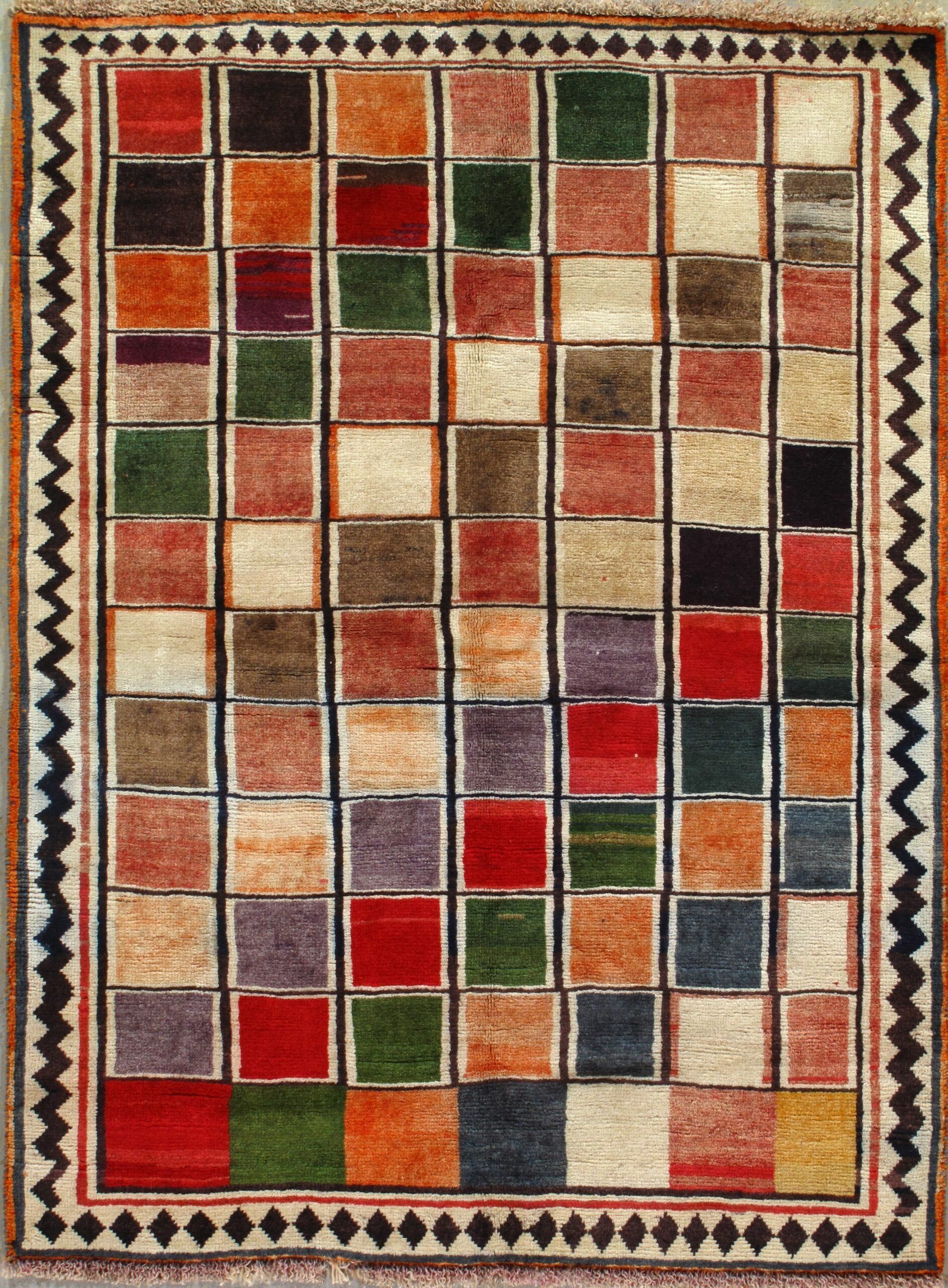 A colorful rug with squares of different colors on it