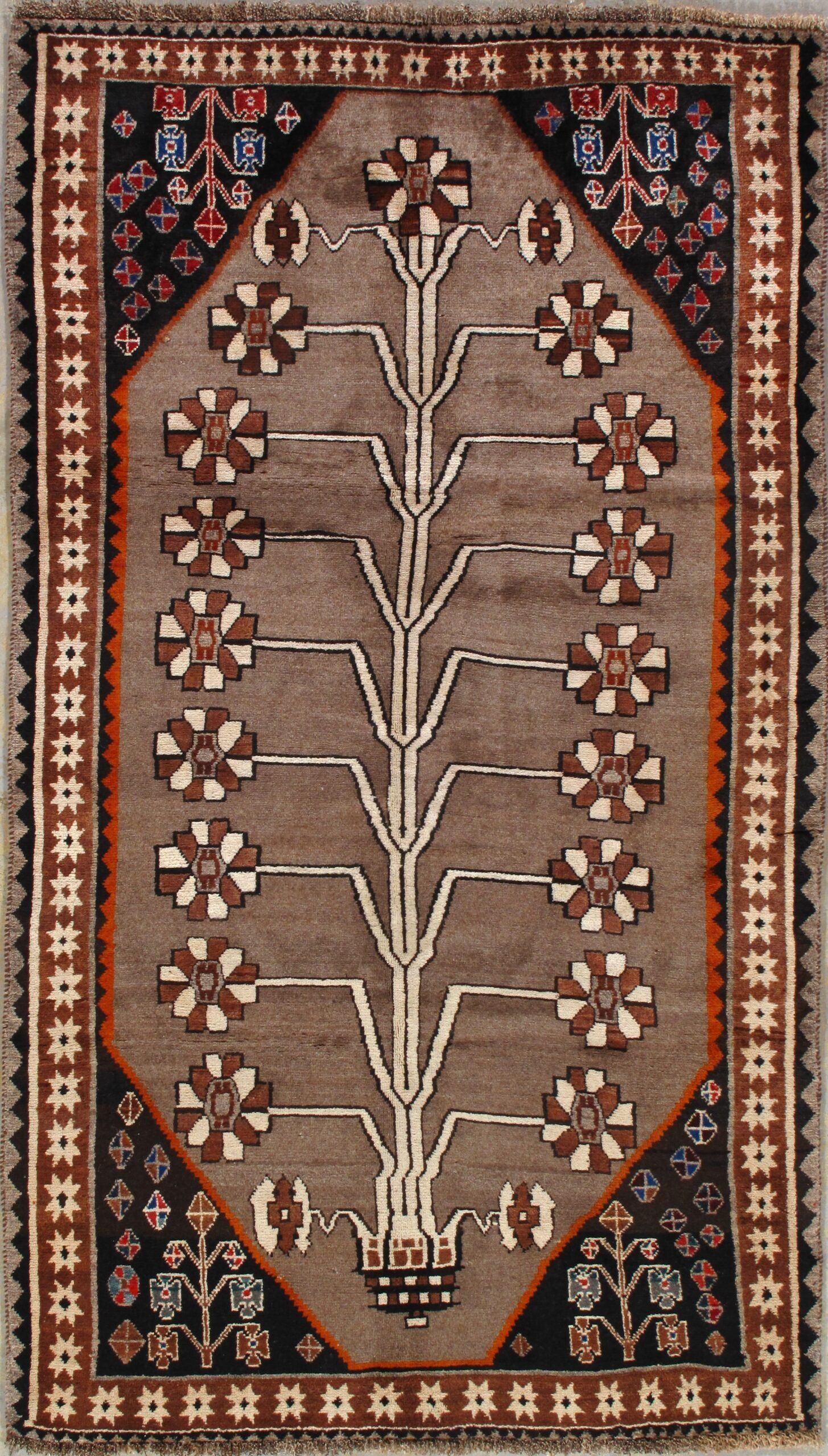 A rug with a tree and flowers on it