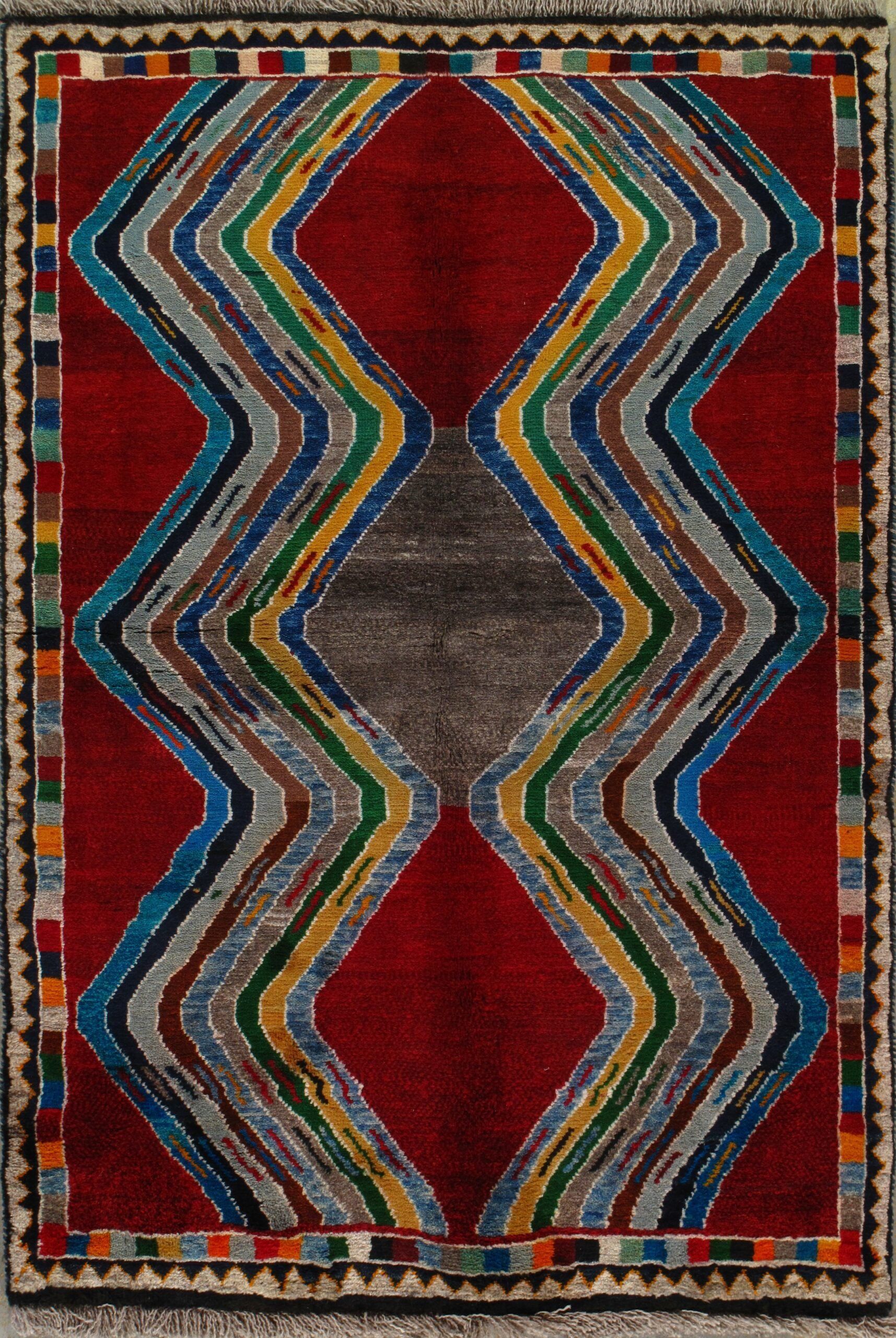 A red rug with a colorful pattern on it