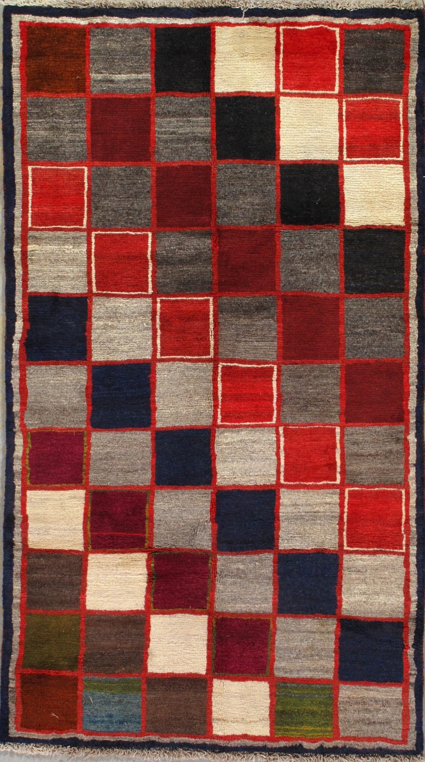 A rug with red white and blue squares on it