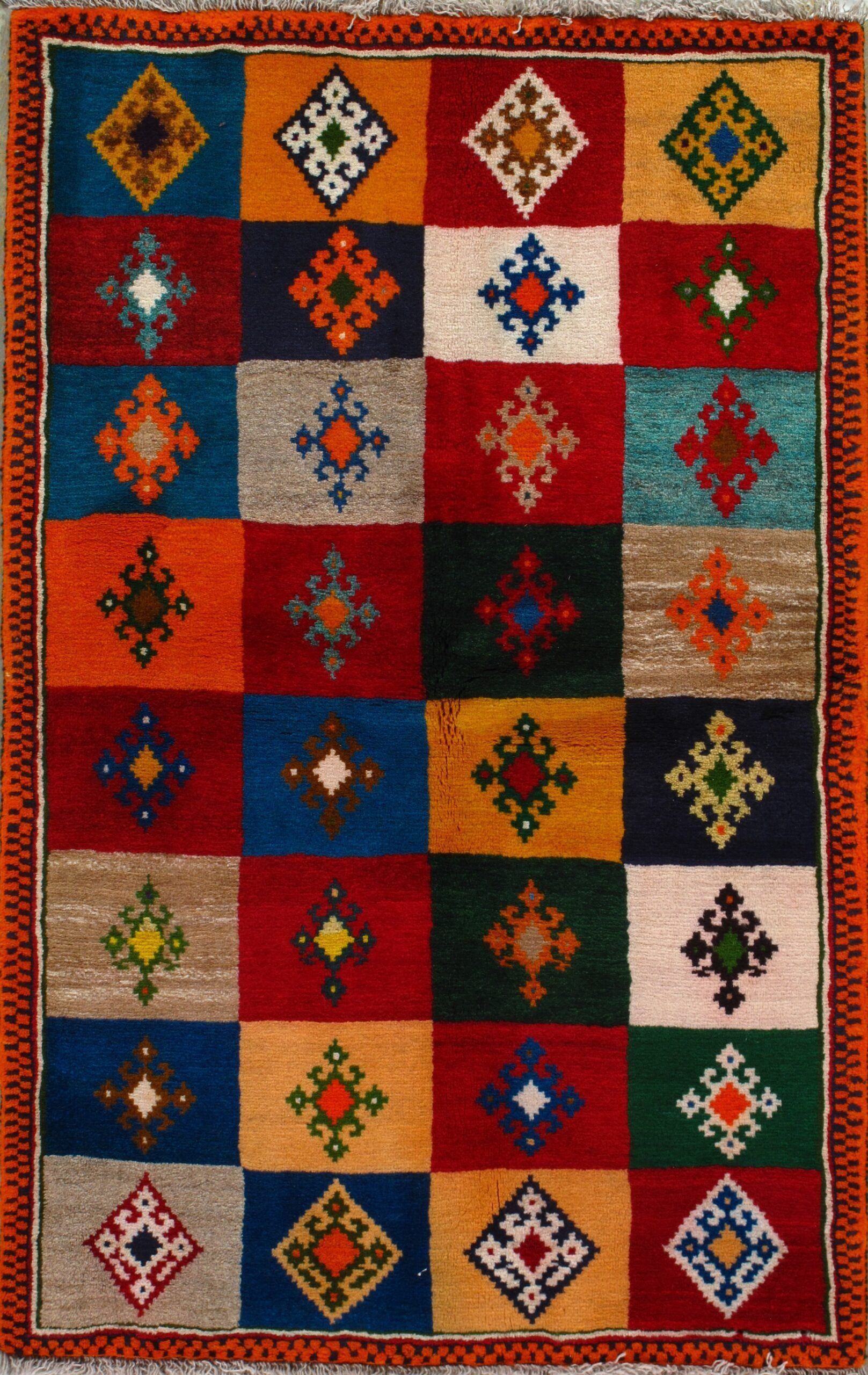 A colorful rug with squares and diamonds on it