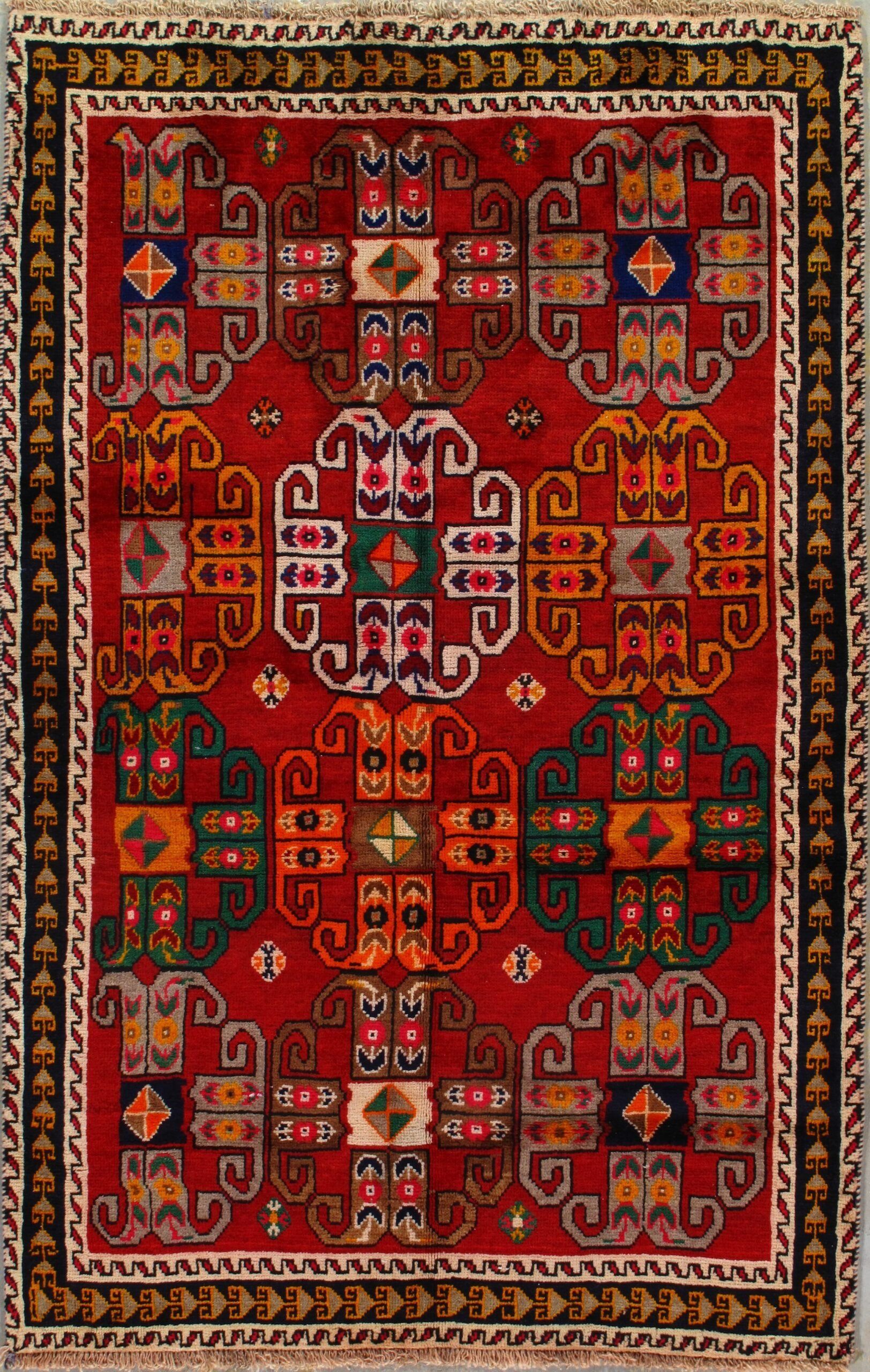 A red rug with a colorful pattern on it