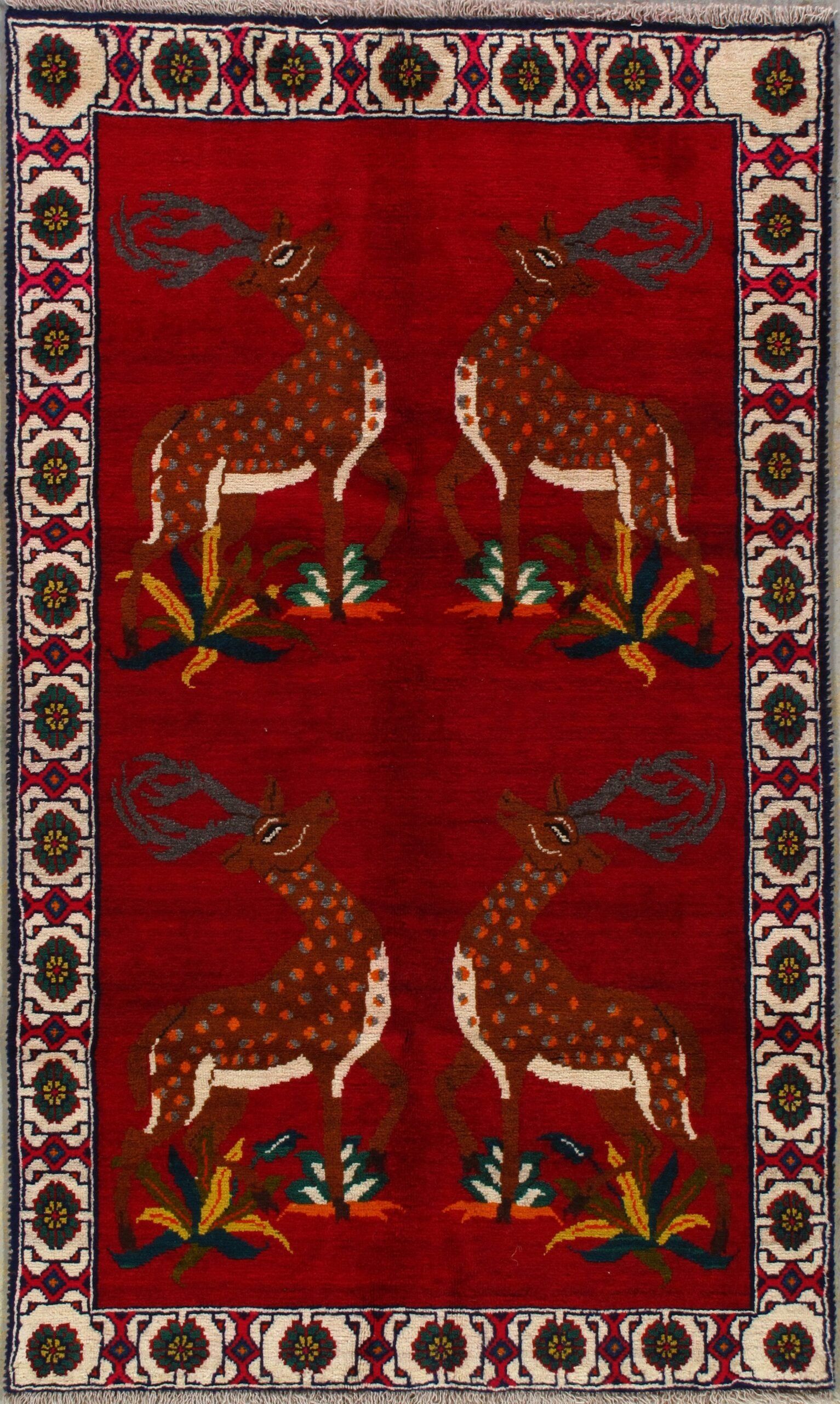 A red rug with two deer on it