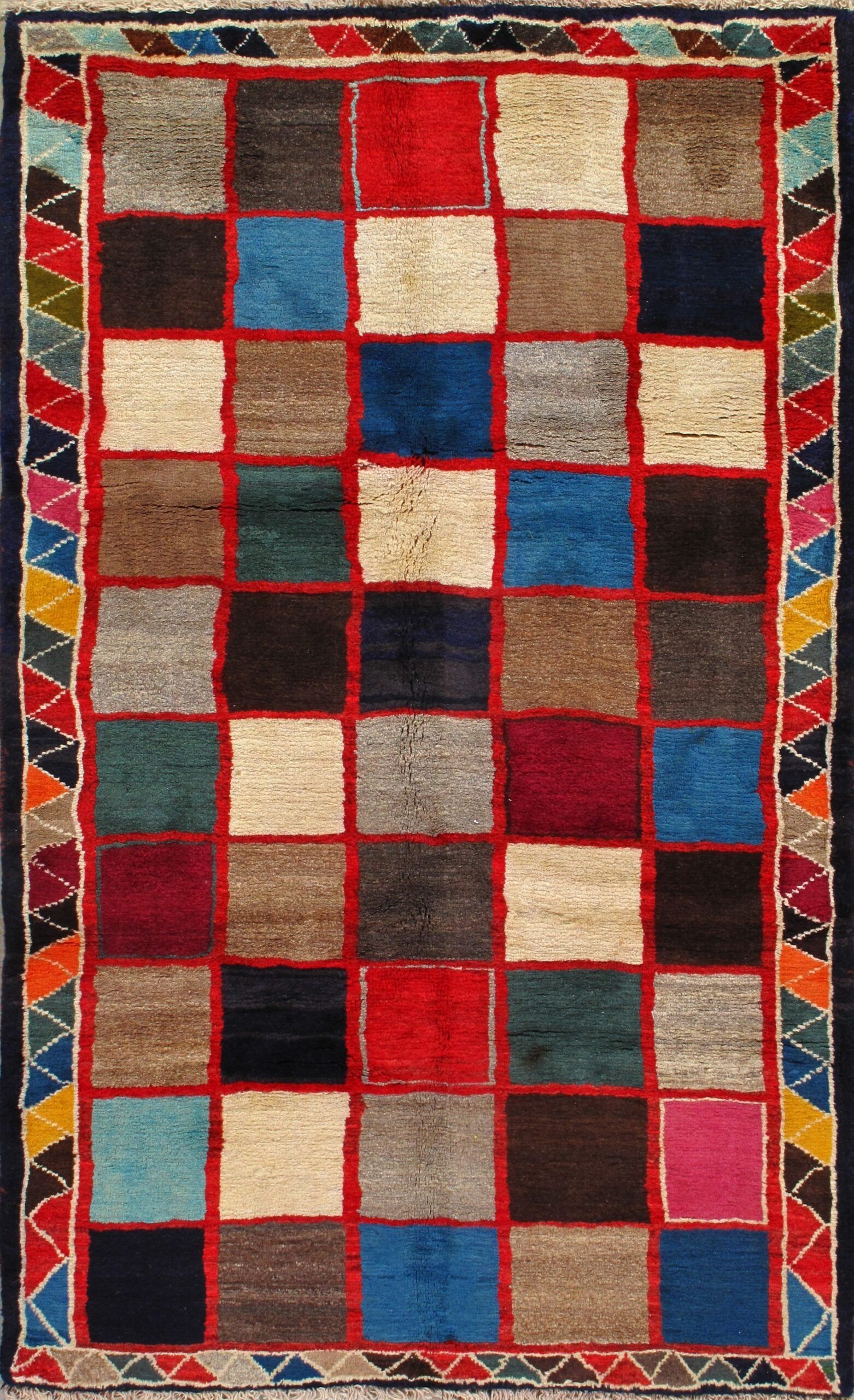 A colorful rug with squares and triangles on it