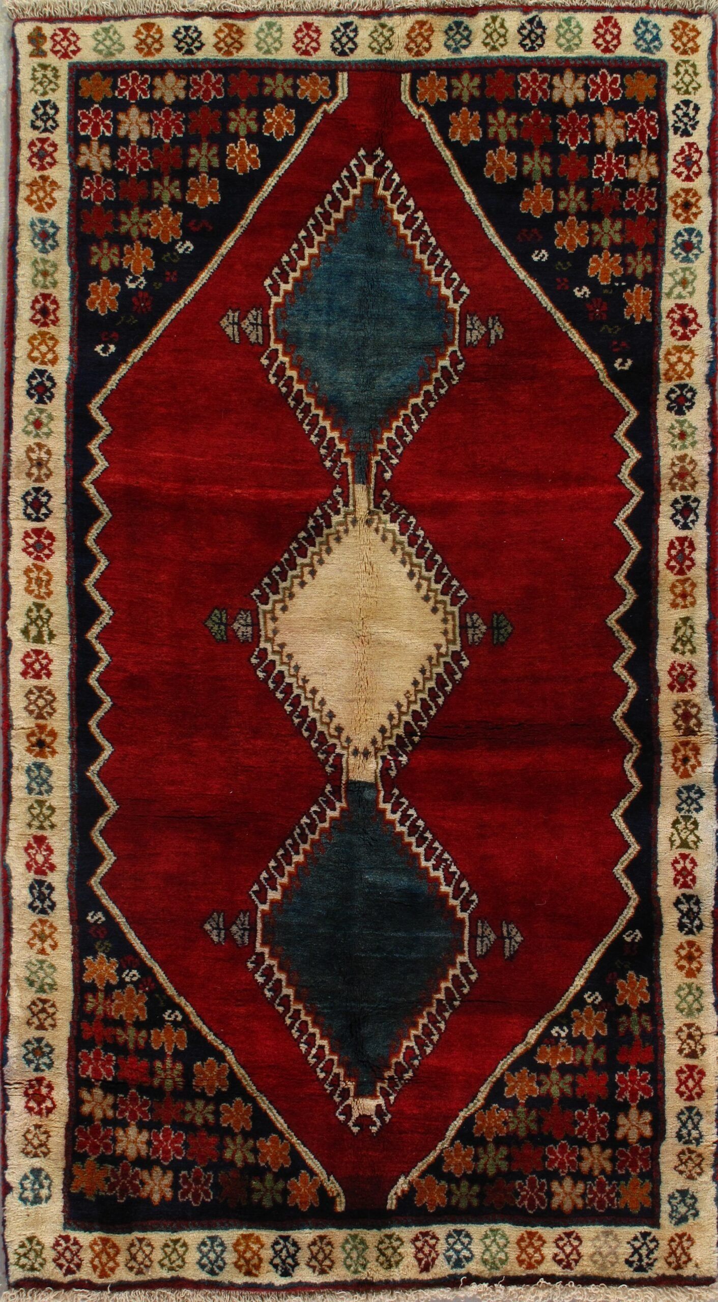 A red rug with blue and white diamonds on it
