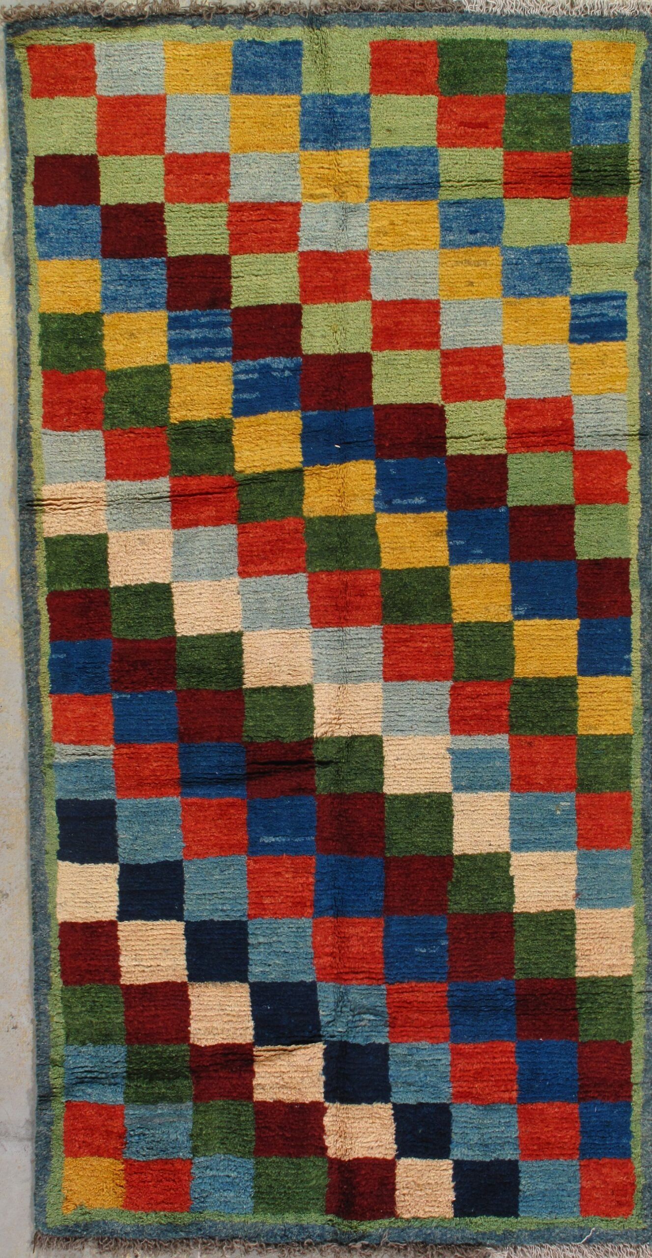 A colorful rug with a checkered pattern on it