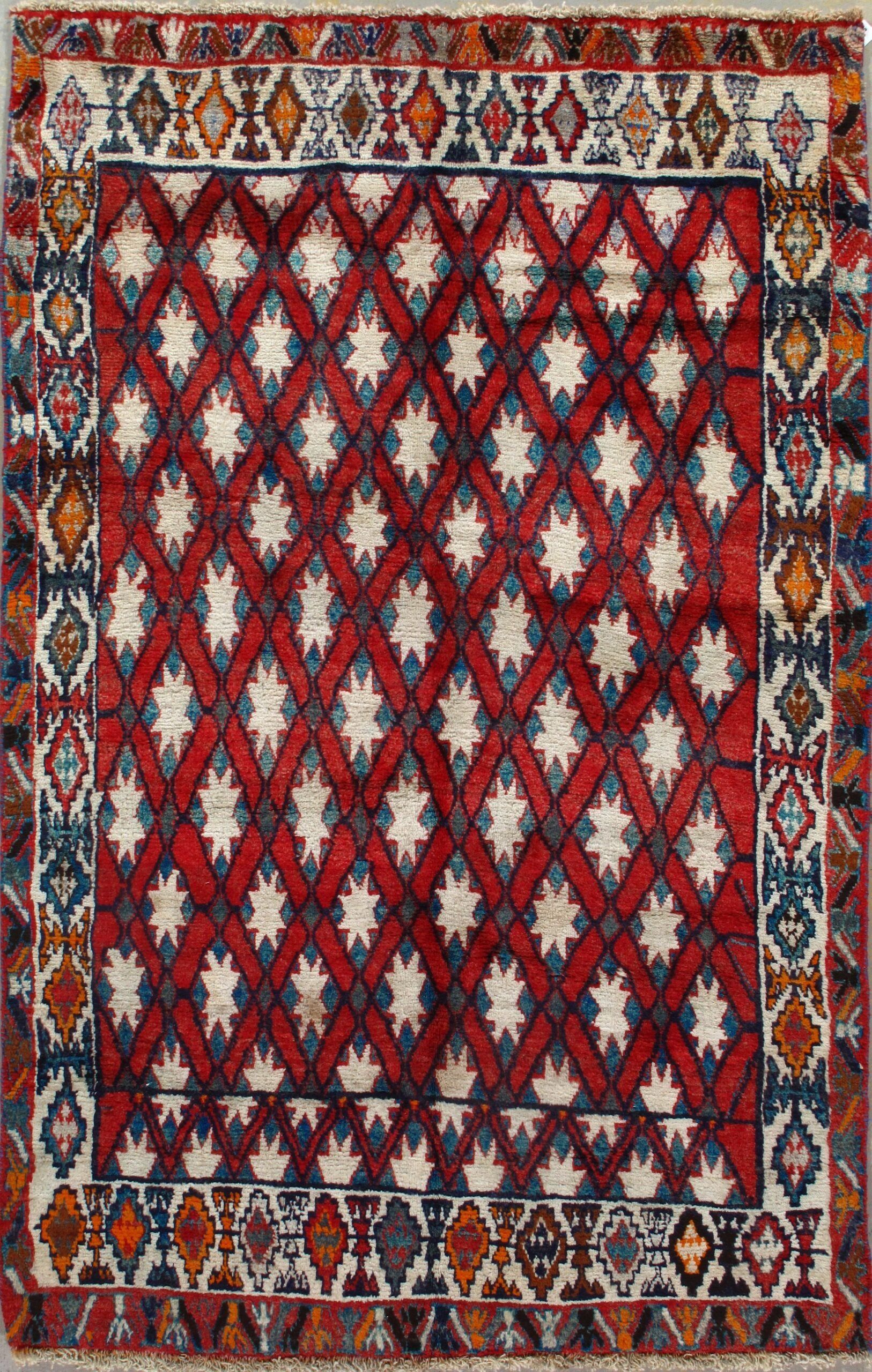 A rug with a red , white and blue pattern on it