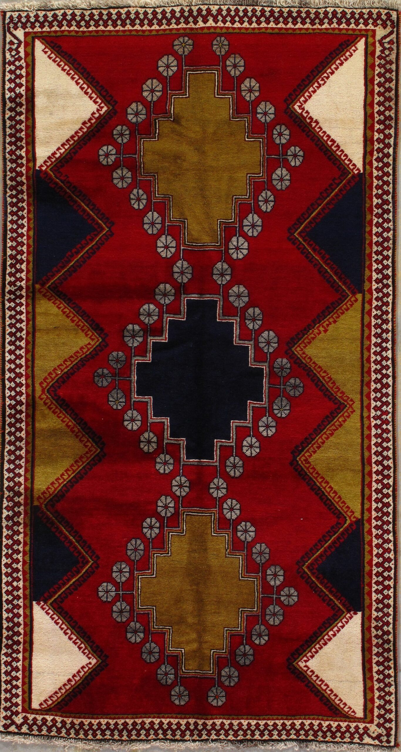 A red and black rug with a geometric pattern on it.
