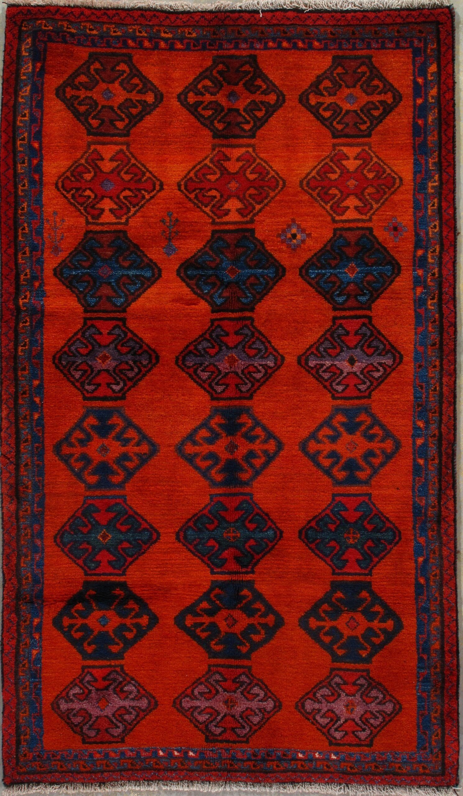 A red rug with a blue and red pattern on it