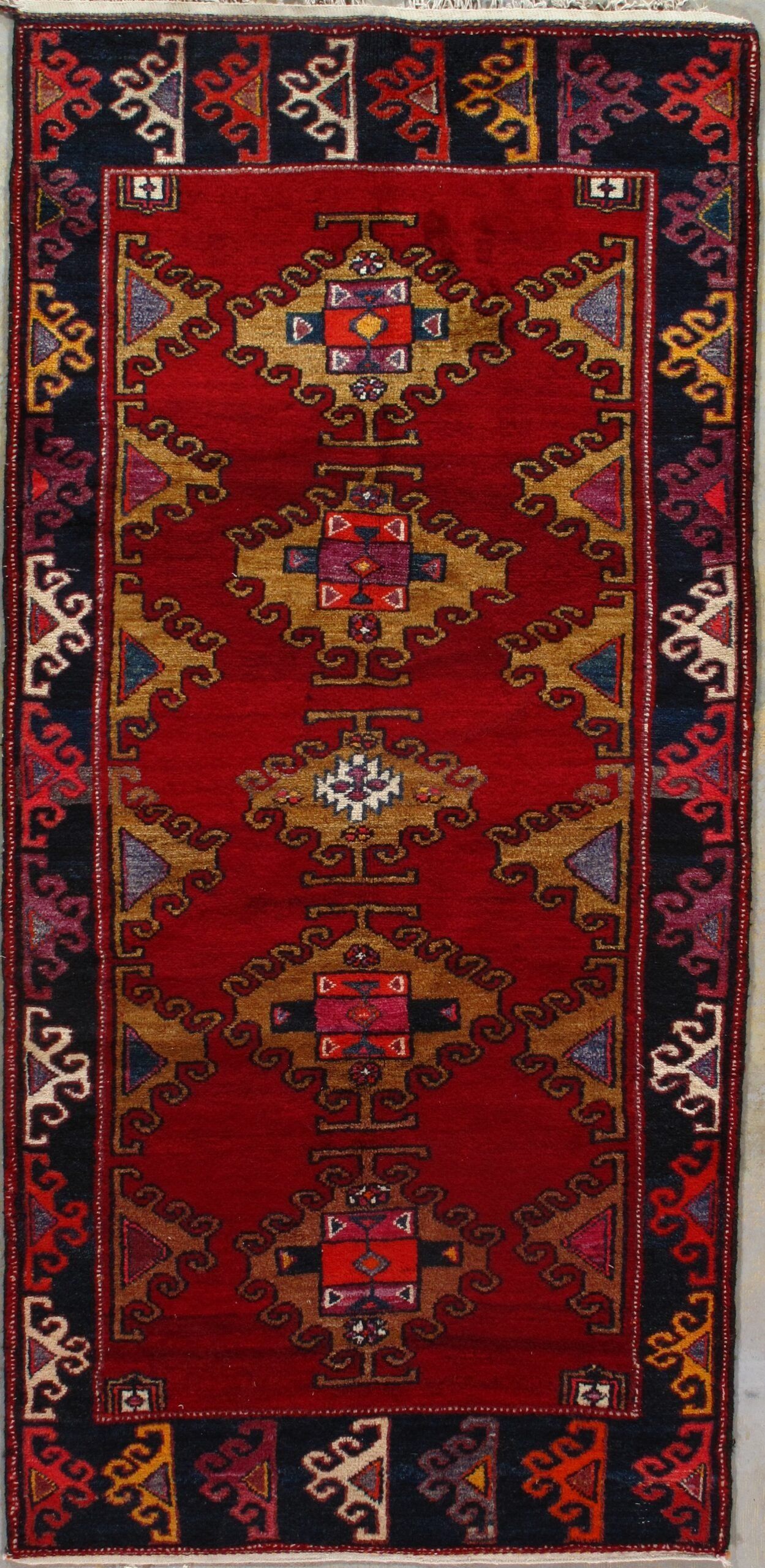 A red rug with a geometric pattern on it