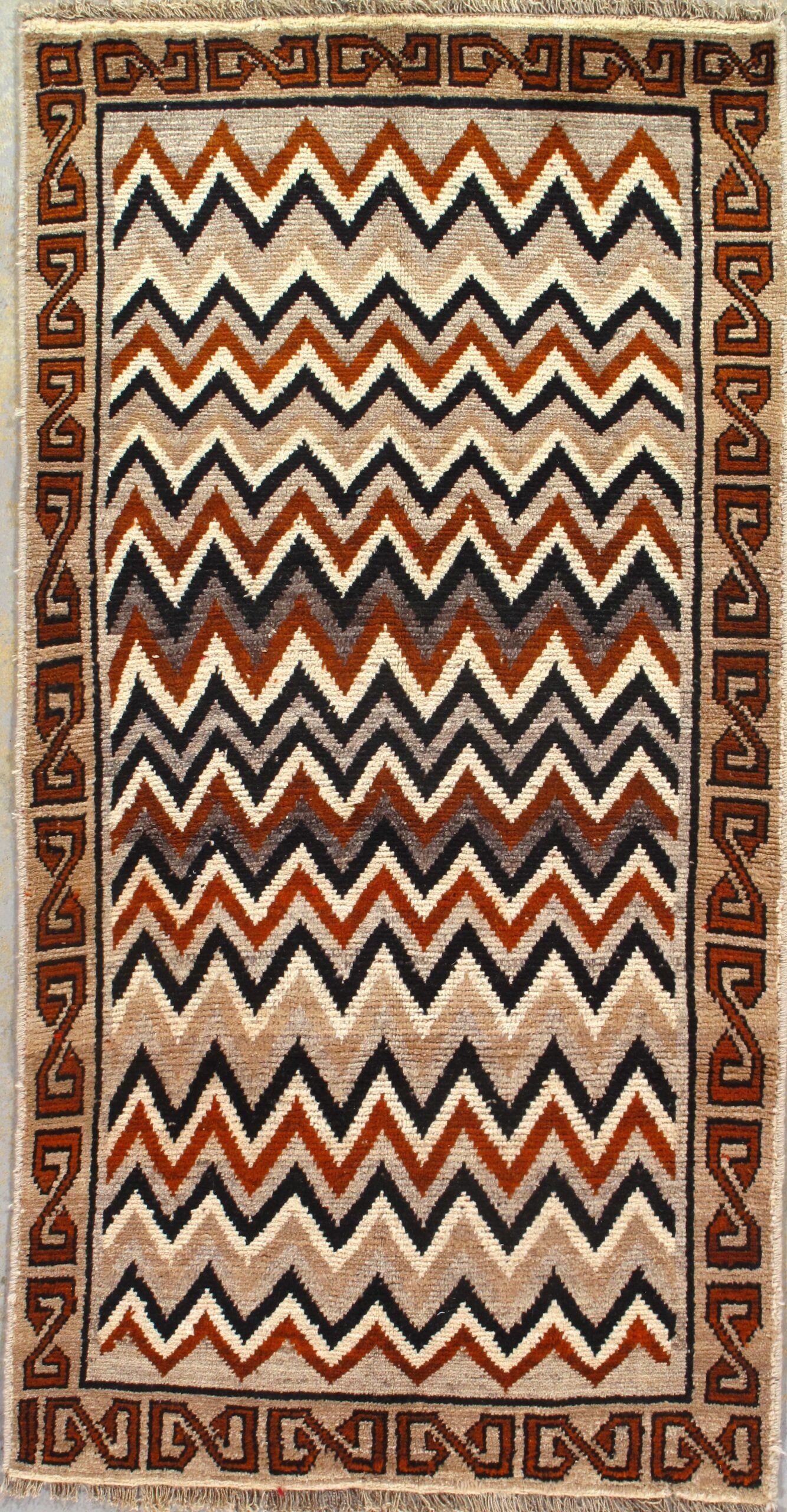A rug with a chevron pattern on it is sitting on a table.
