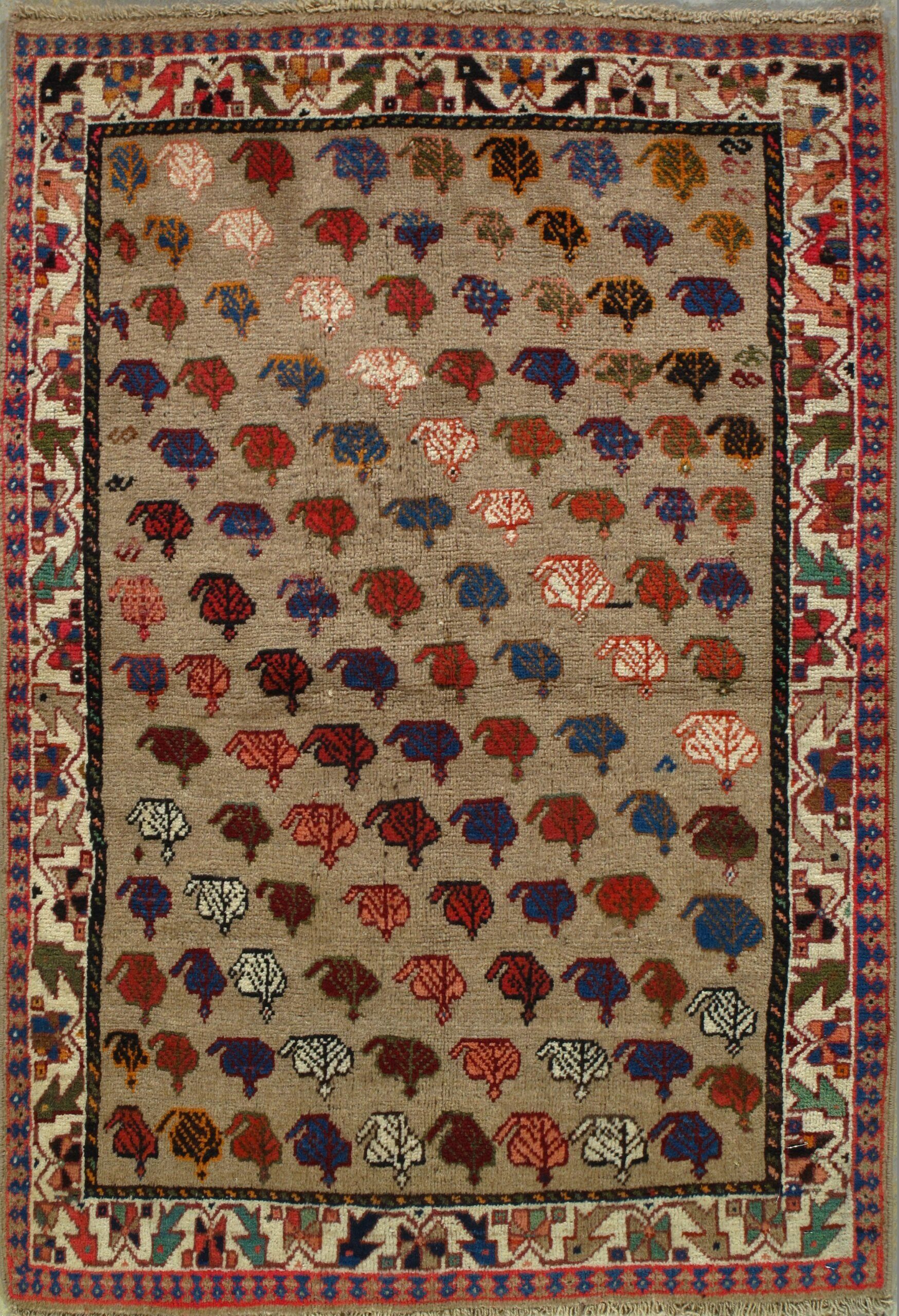 A rug with a pattern of sheep and trees on it.