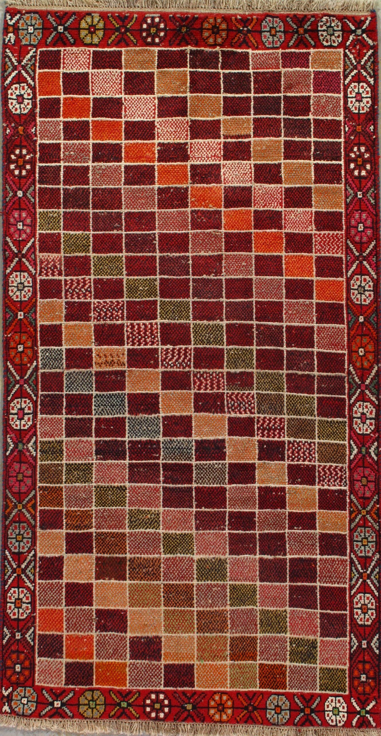 A colorful rug with a brick pattern on it is sitting on a table.