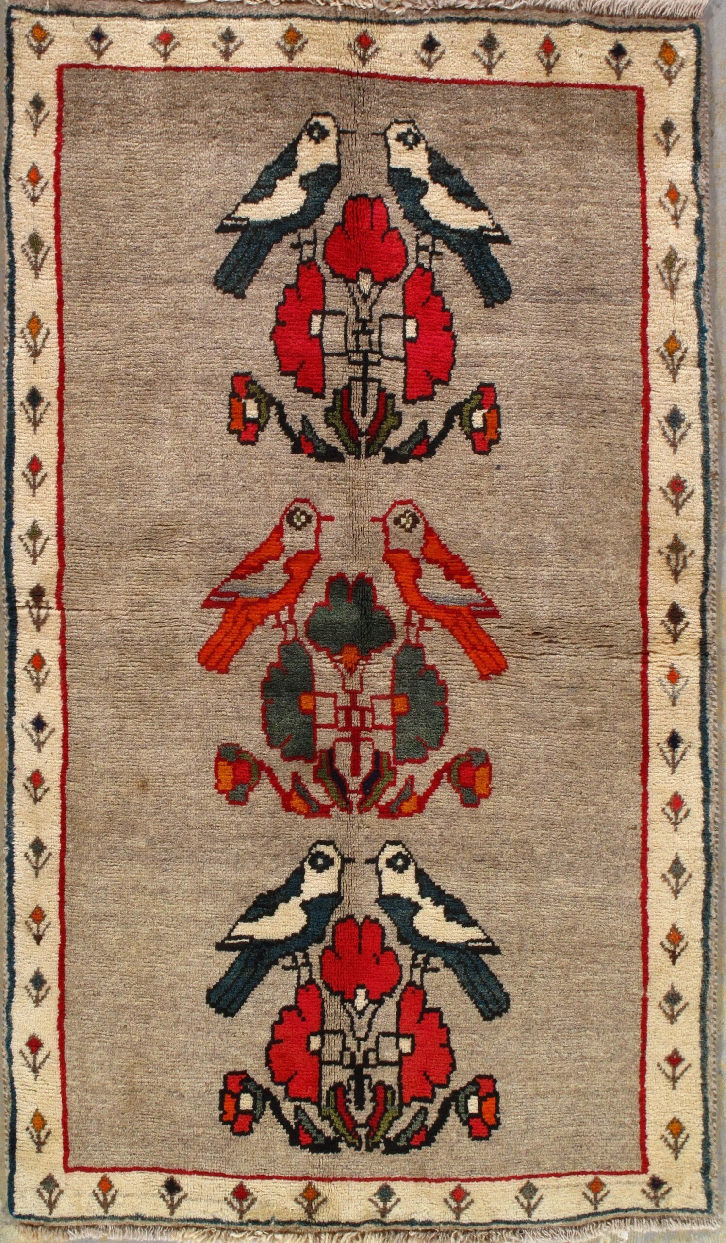 A rug with birds and flowers on it