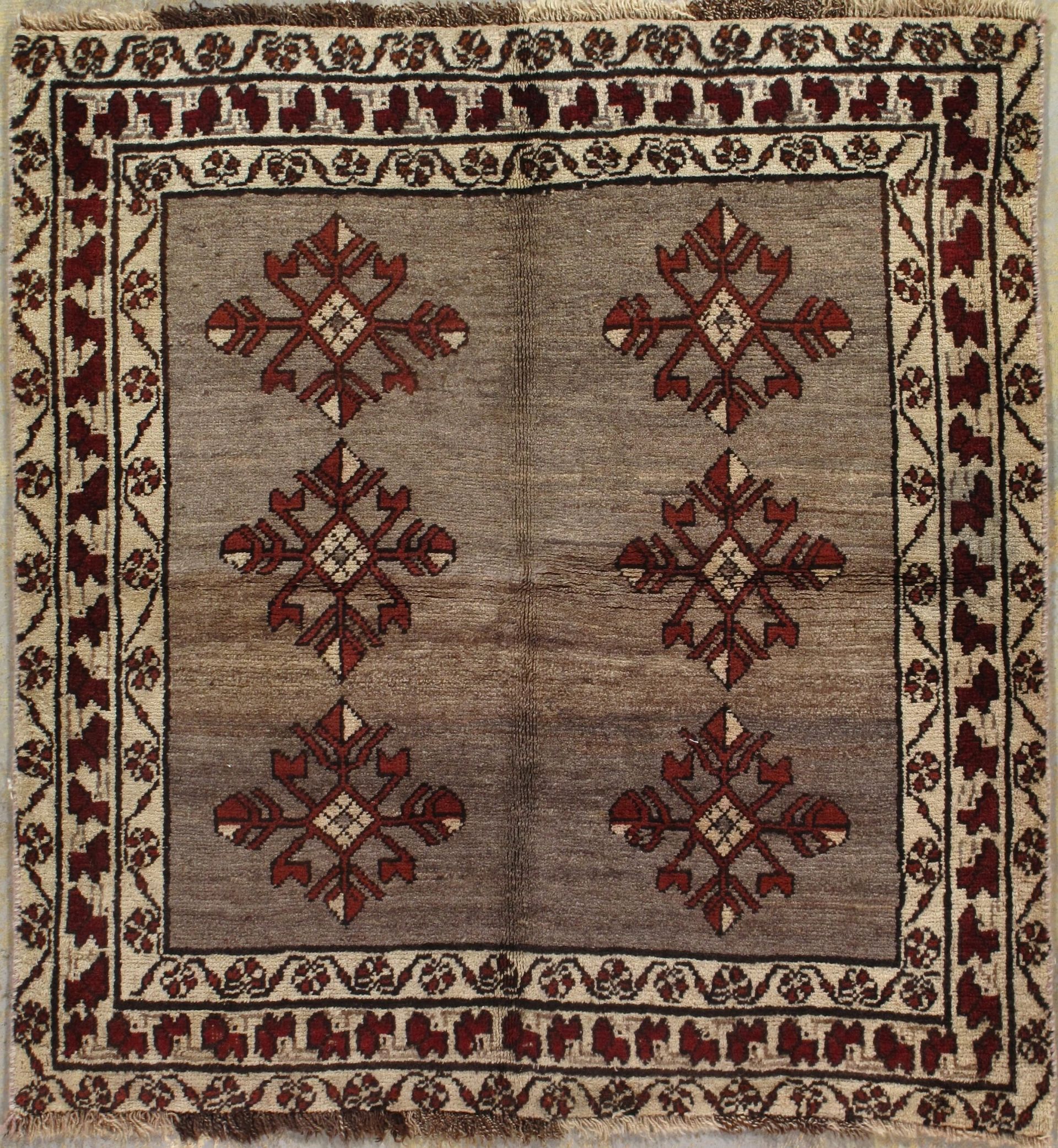 A square rug with a floral pattern on it