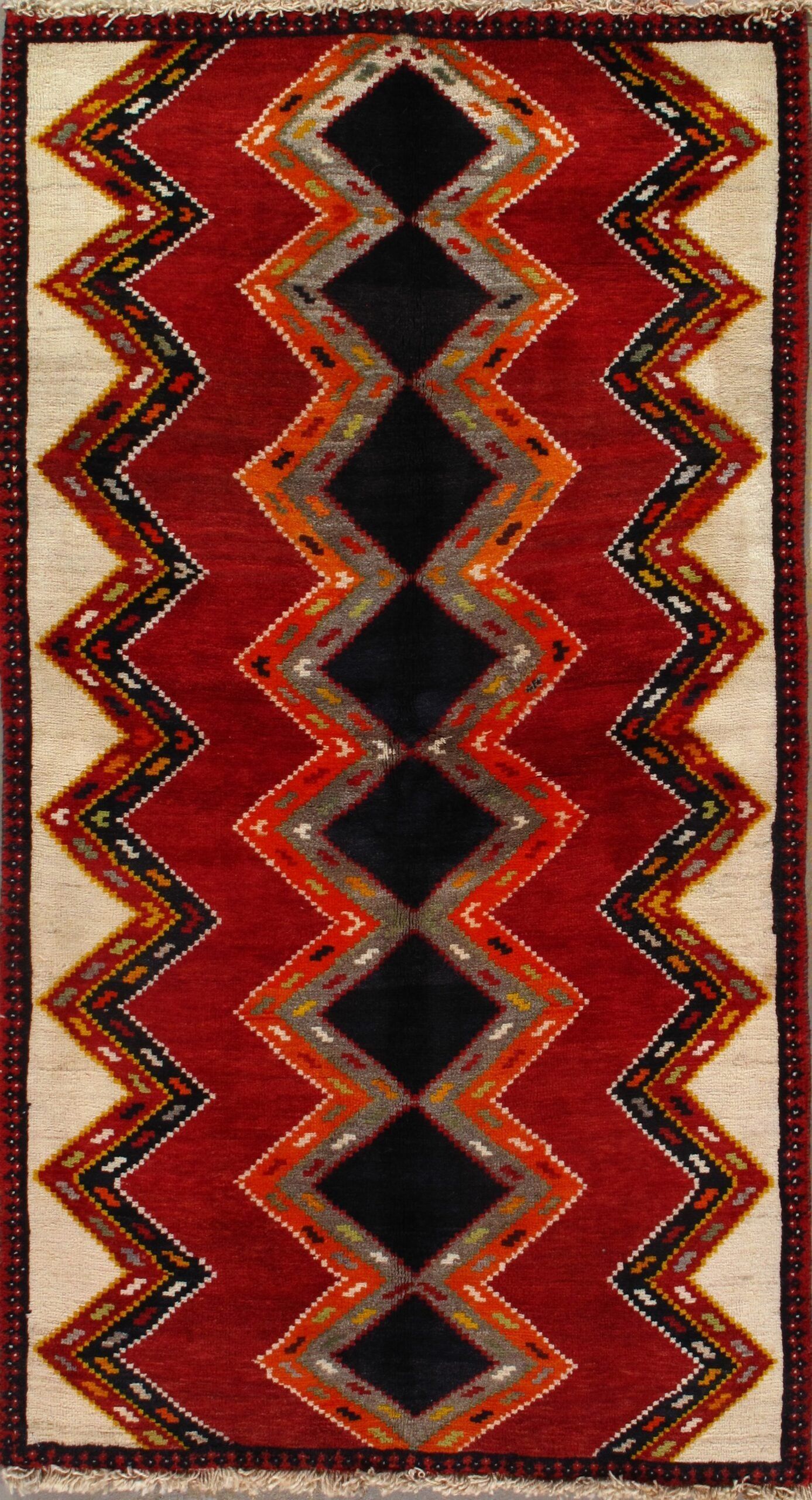 A red and black rug with a diamond pattern